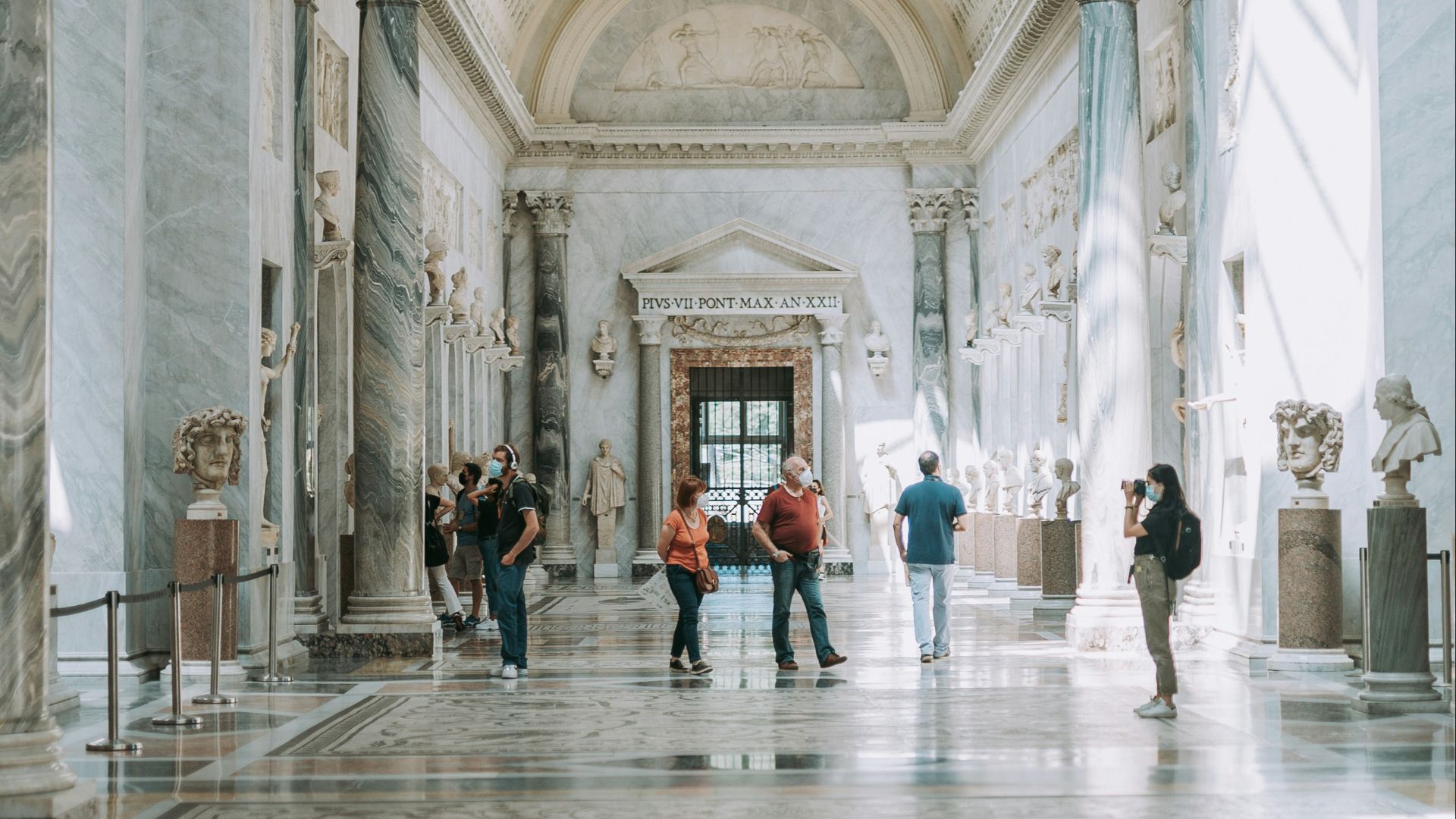 people walking inside white concrete building