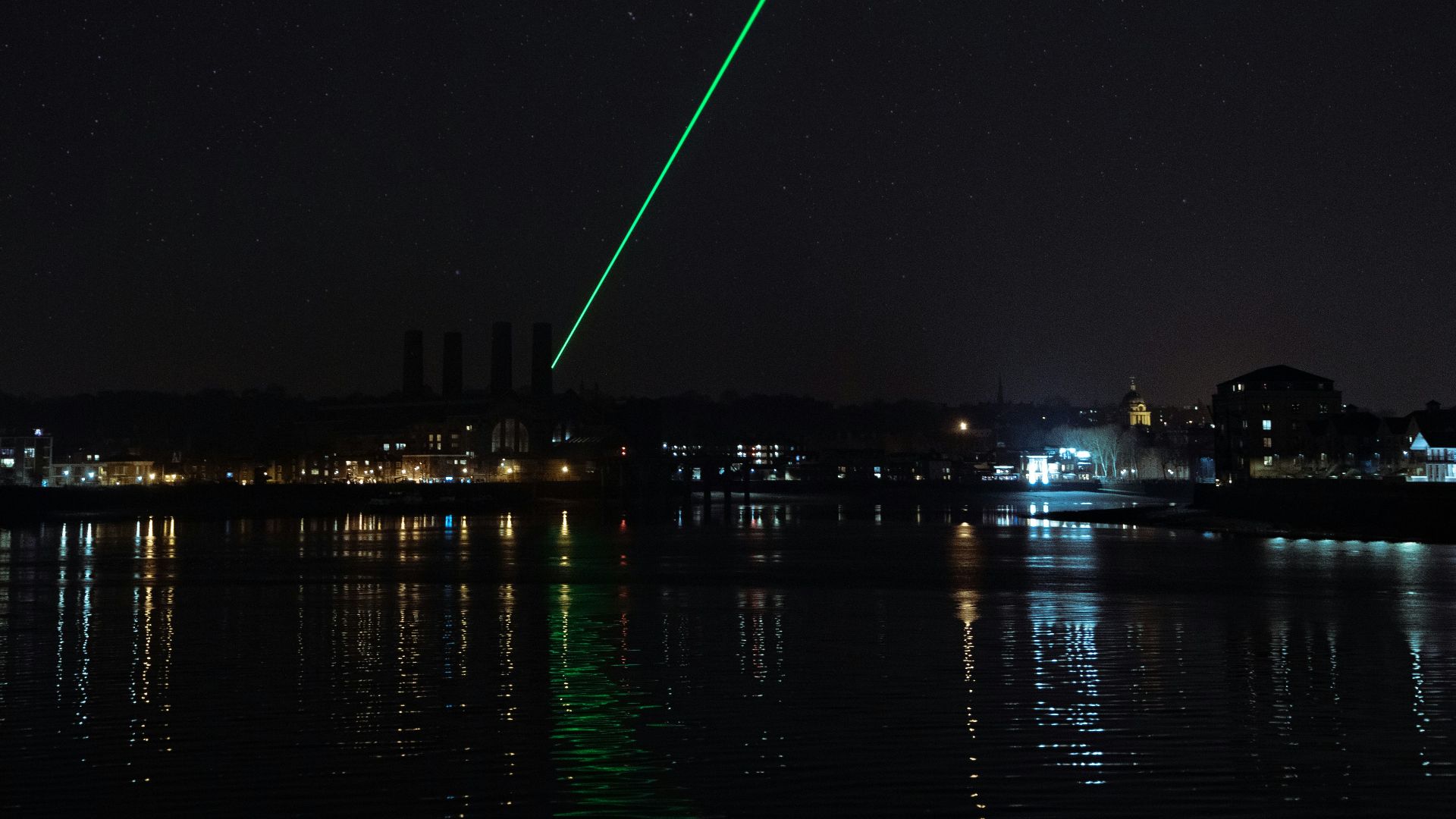 city buildings near body of water during nighttime