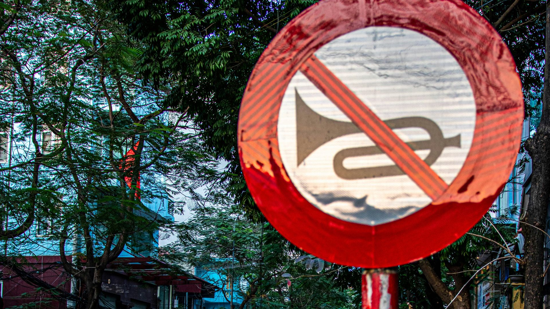 A red and white sign sitting on the side of a road