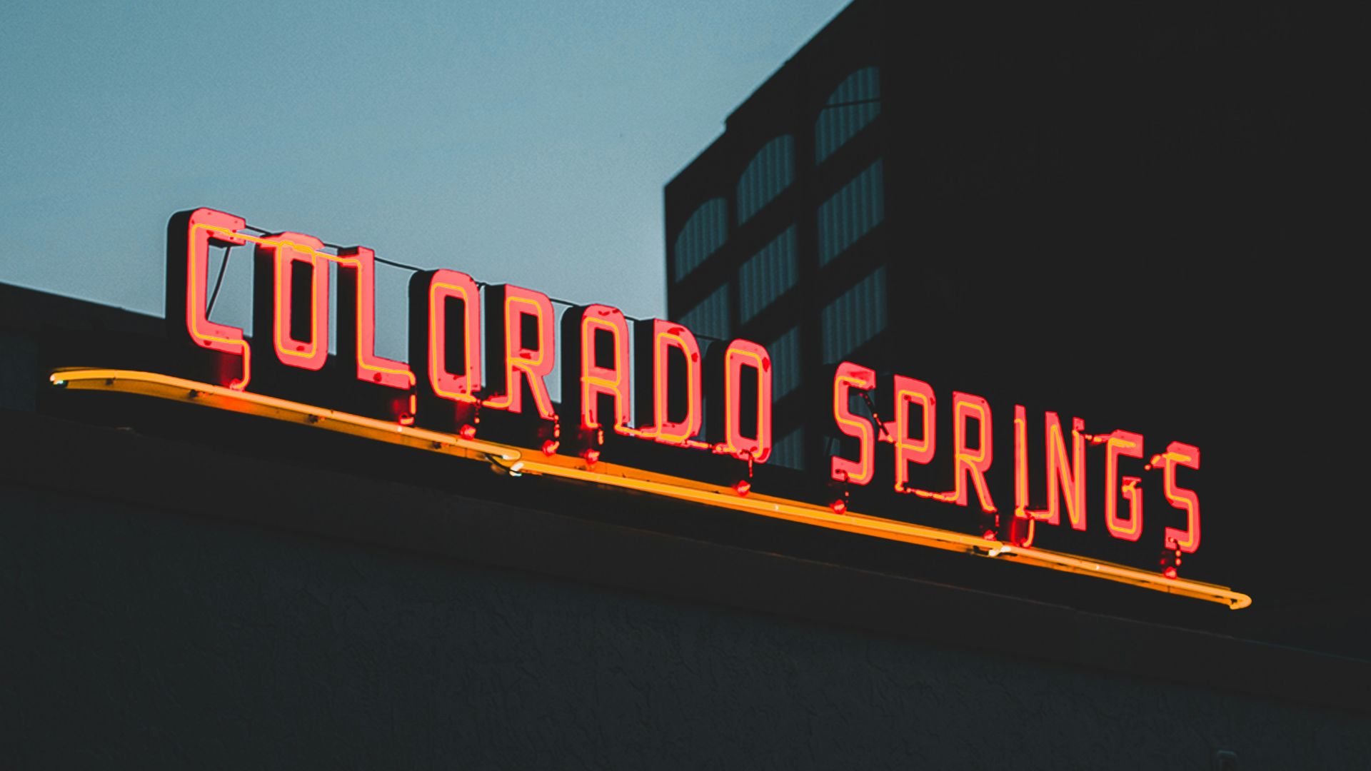 a neon sign on the side of a building