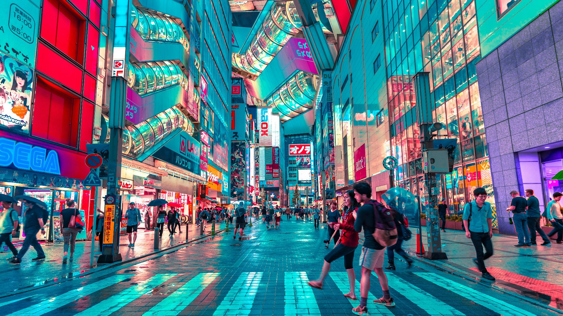 people walking on road near well-lit buildings
