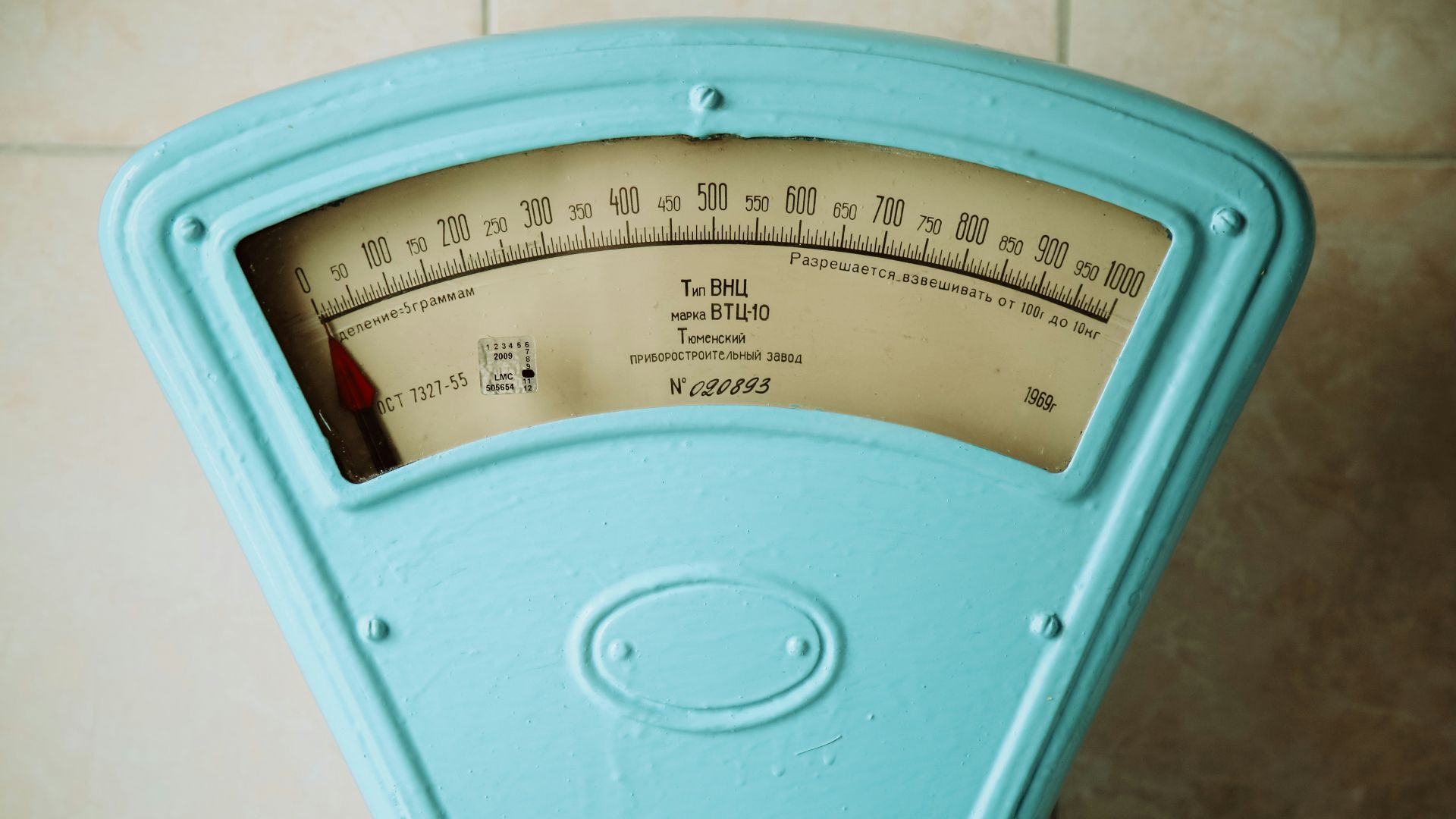 a close up of a meter on a tiled wall