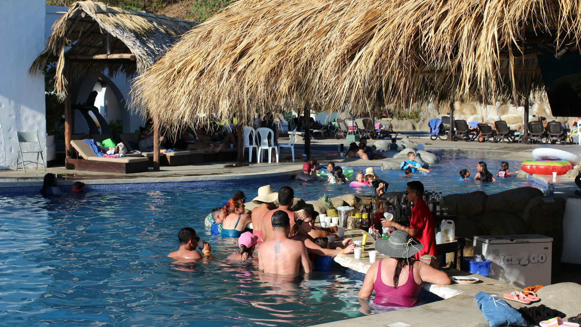 a group of people sitting around a pool