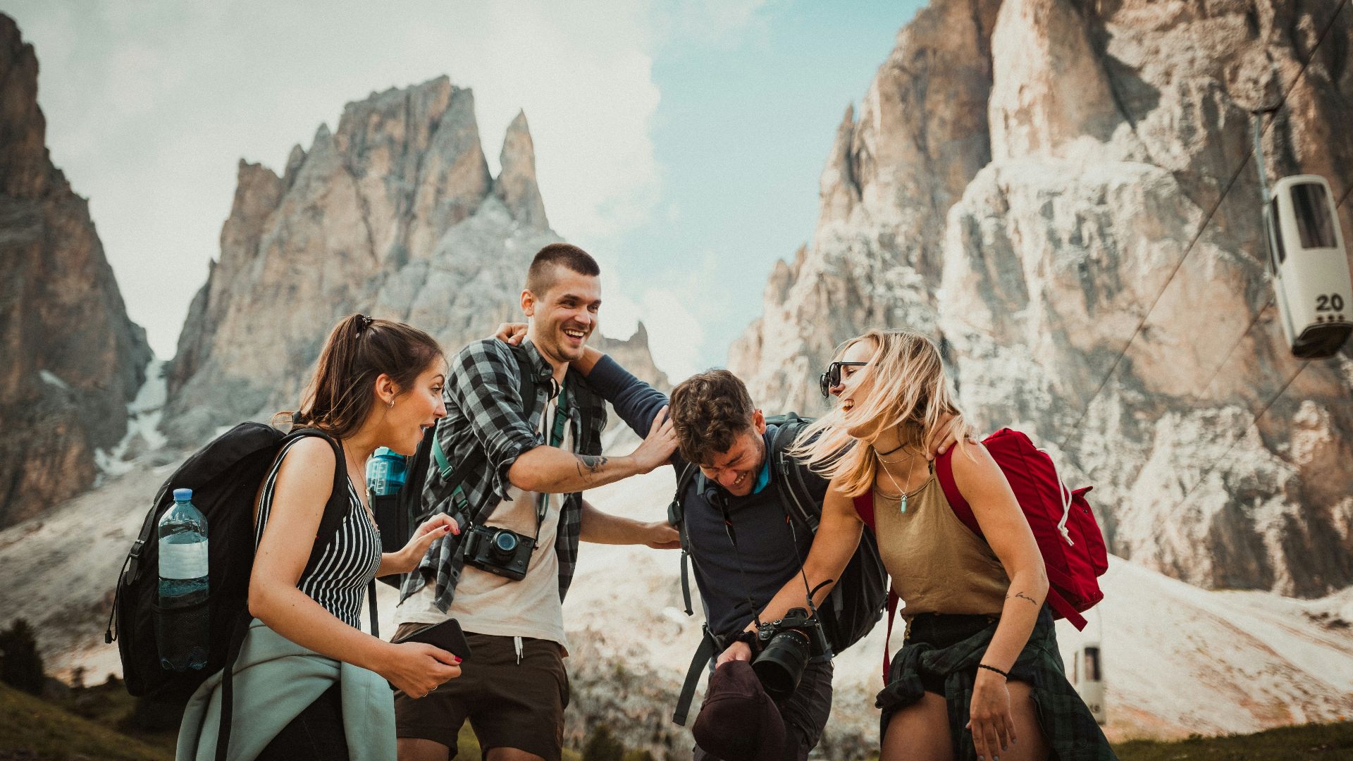low-angle photography of two men playing beside two women