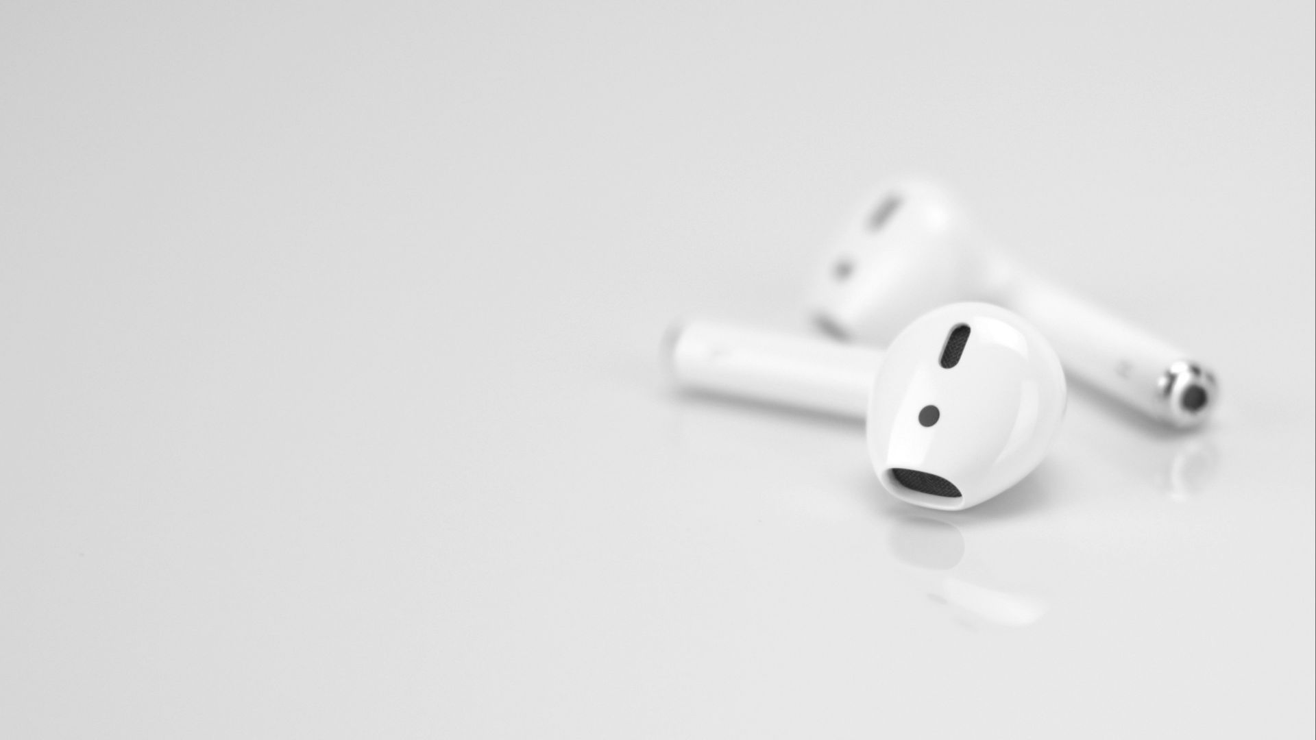Apple AirPods on white surface
