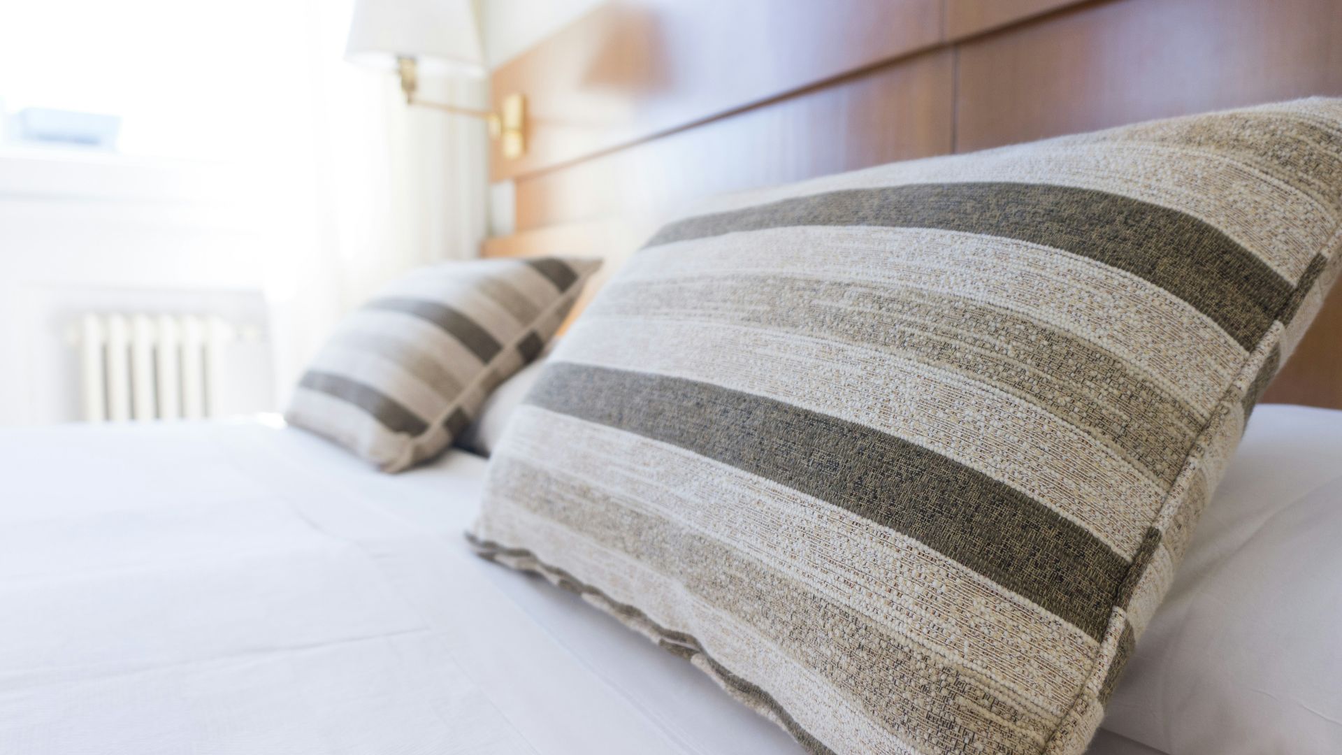 gray and black throw pillow on bed