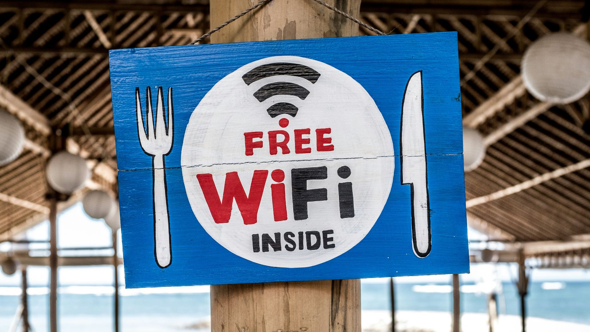 Free WiFi signage on wooden post