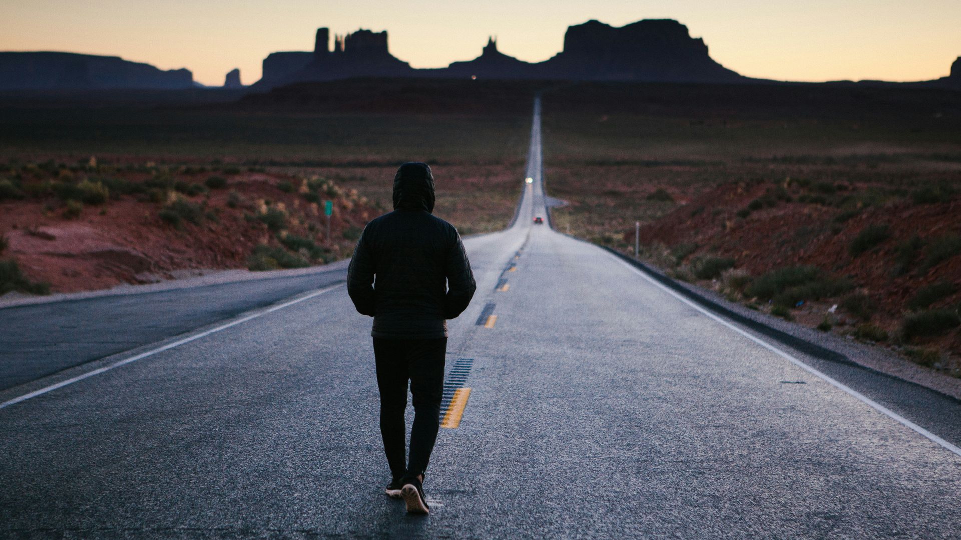 person walking in the center of the road