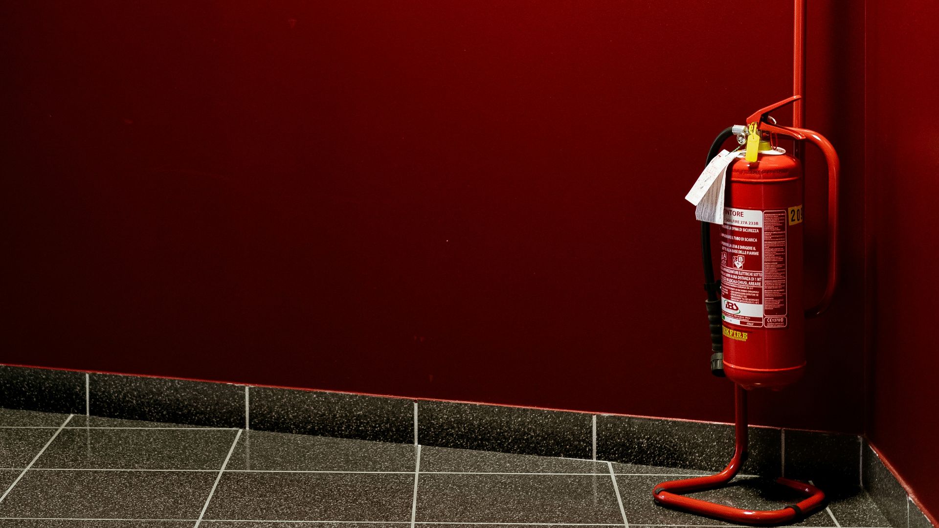 red fire extinguisher on corner