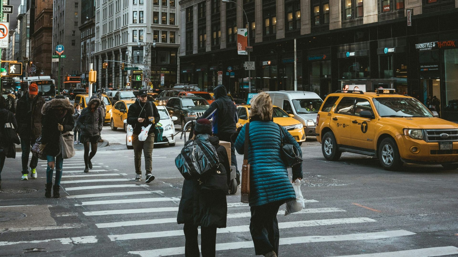 group of people crossing pedestrian lane