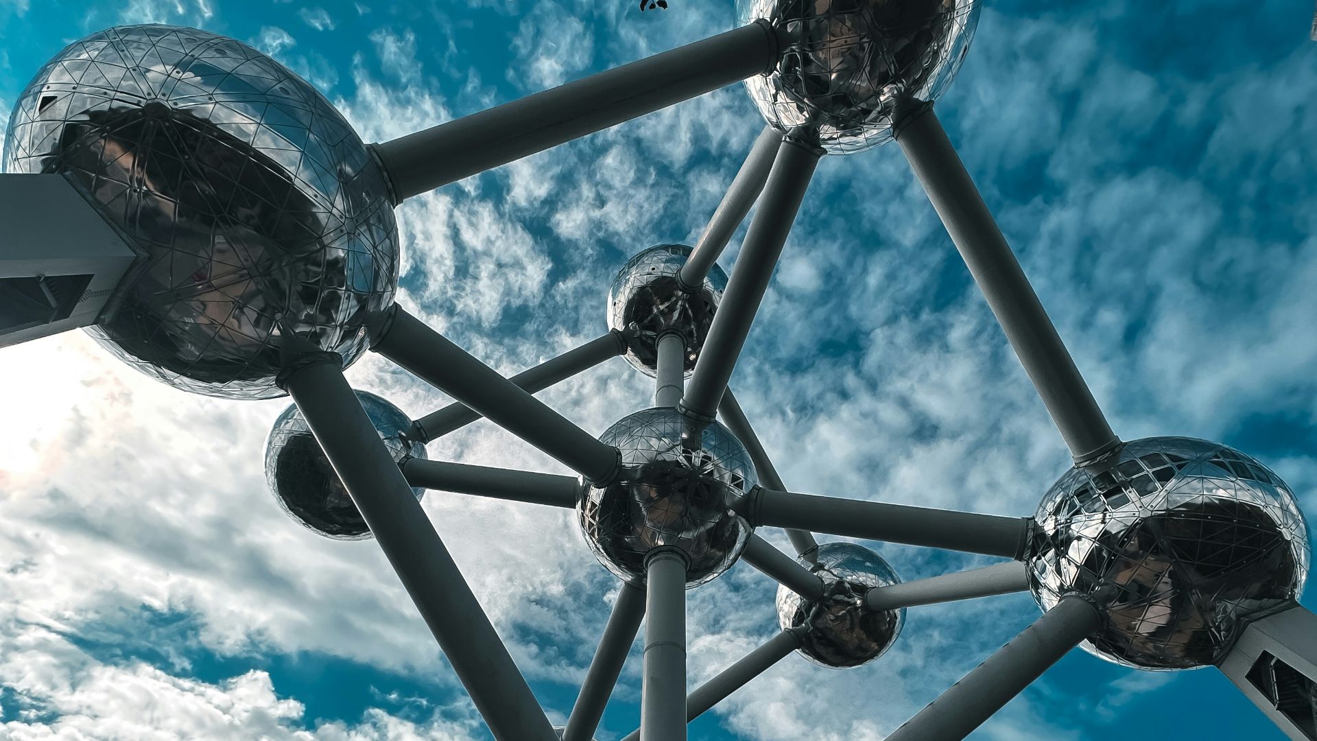 a group of people standing around a metal structure