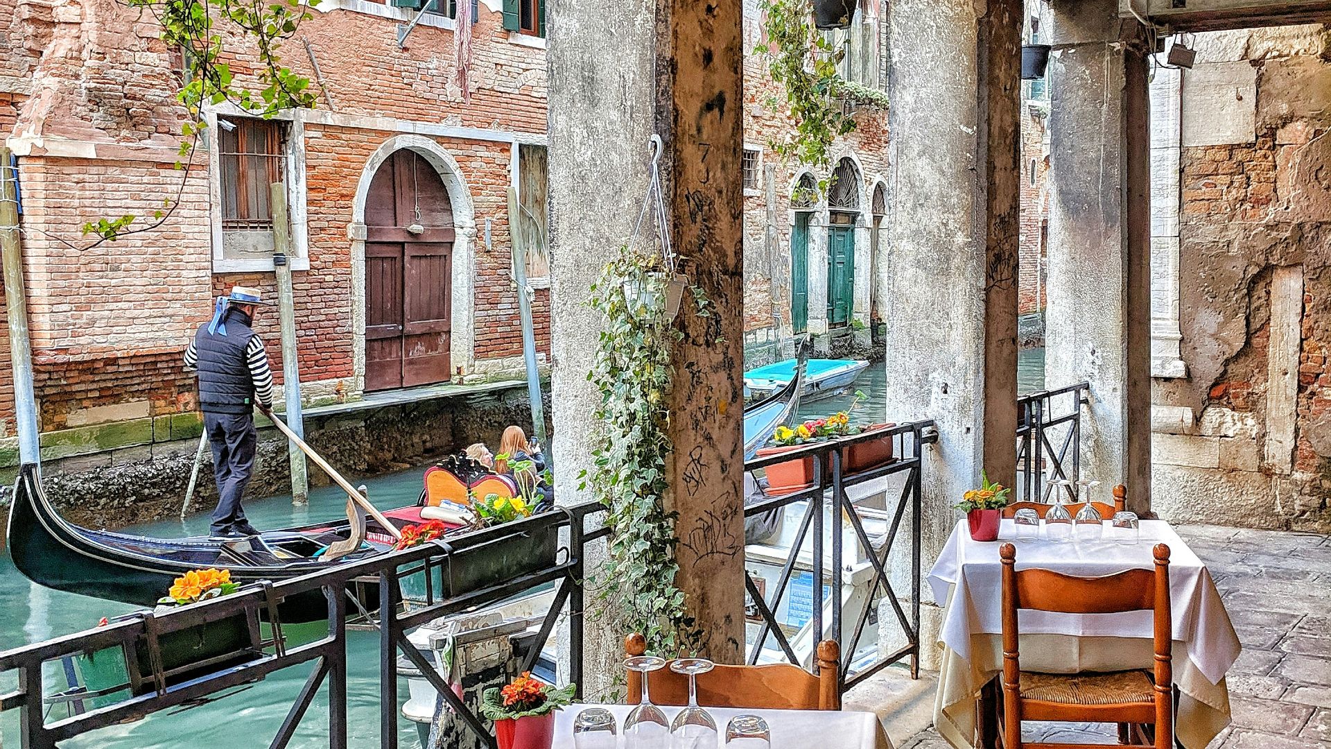 man riding on boat beside restaurant