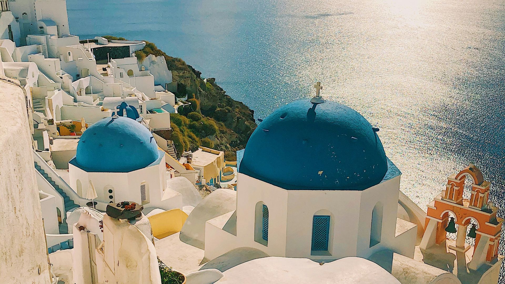 white and blue concrete building near body of water during daytime