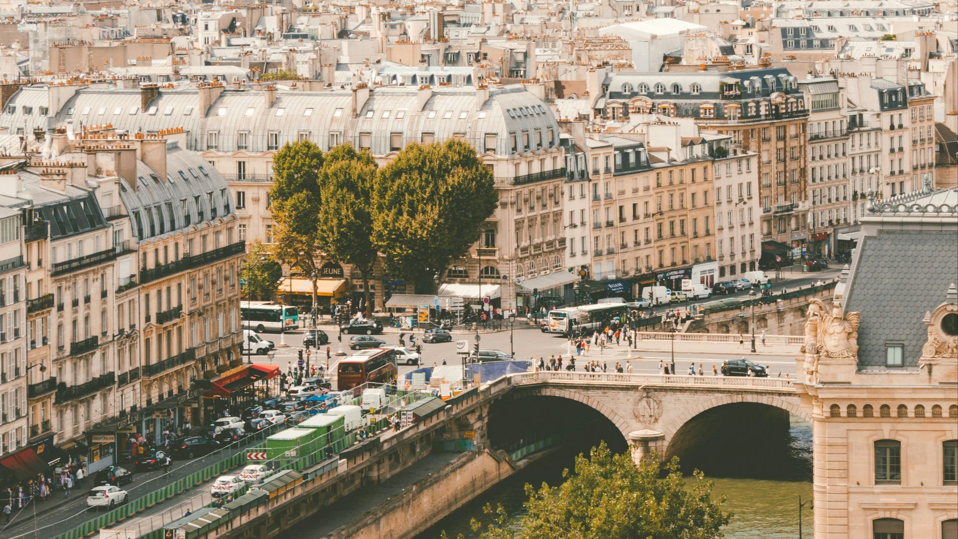 group of people walking near body of water and building under blue sky at daytime
