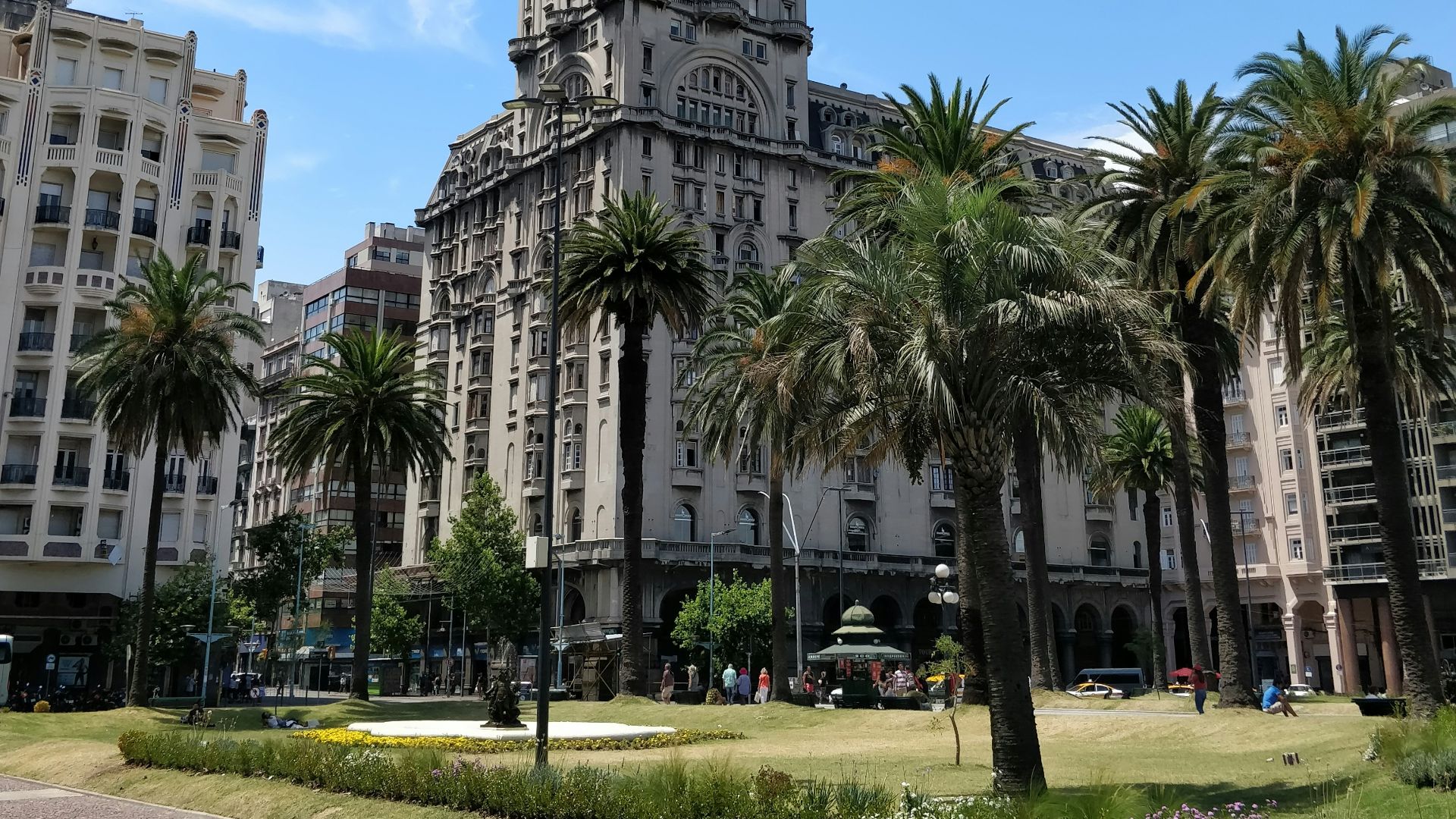 white concrete building near palm trees during daytime