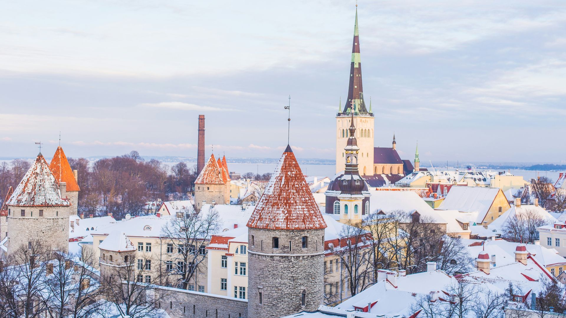 snow covered brown, white, and gray concrete castle under cloudy skies