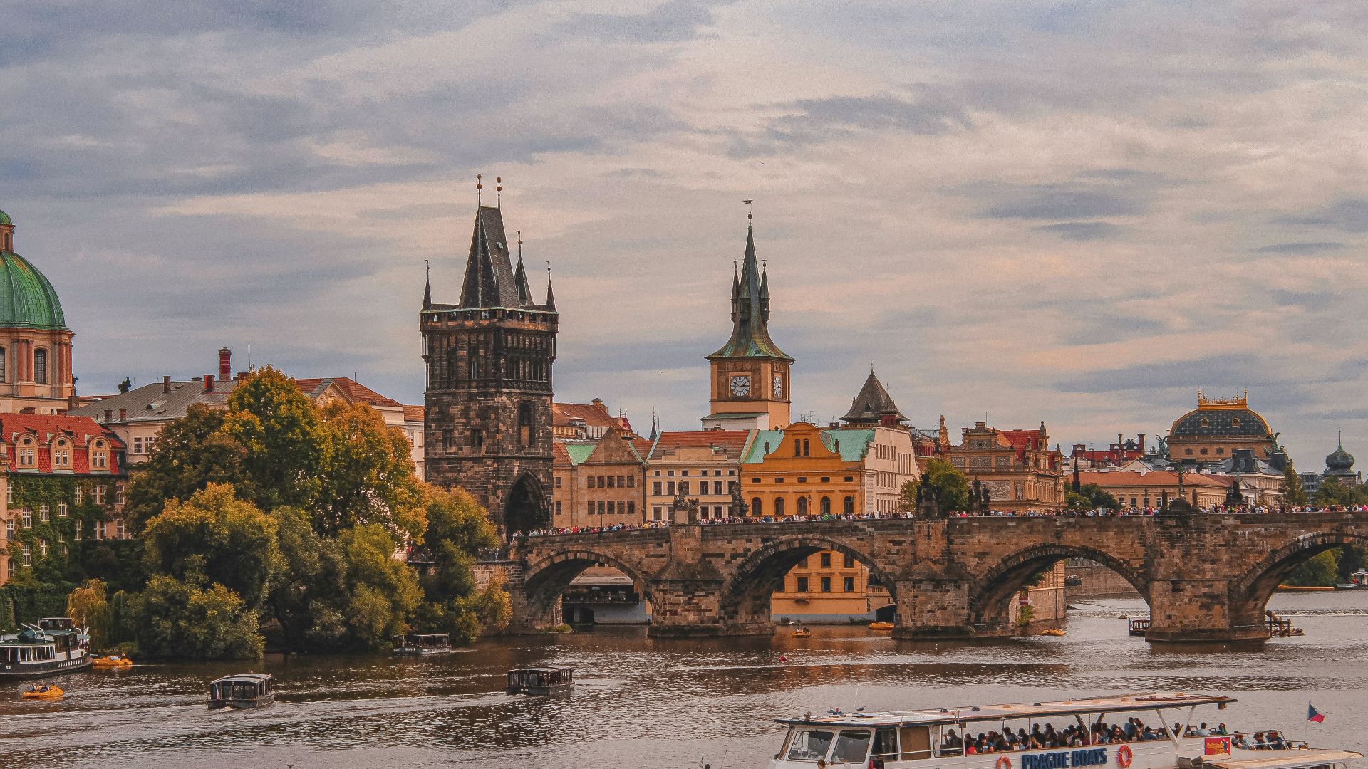 white and brown boat on river near brown concrete building during daytime
