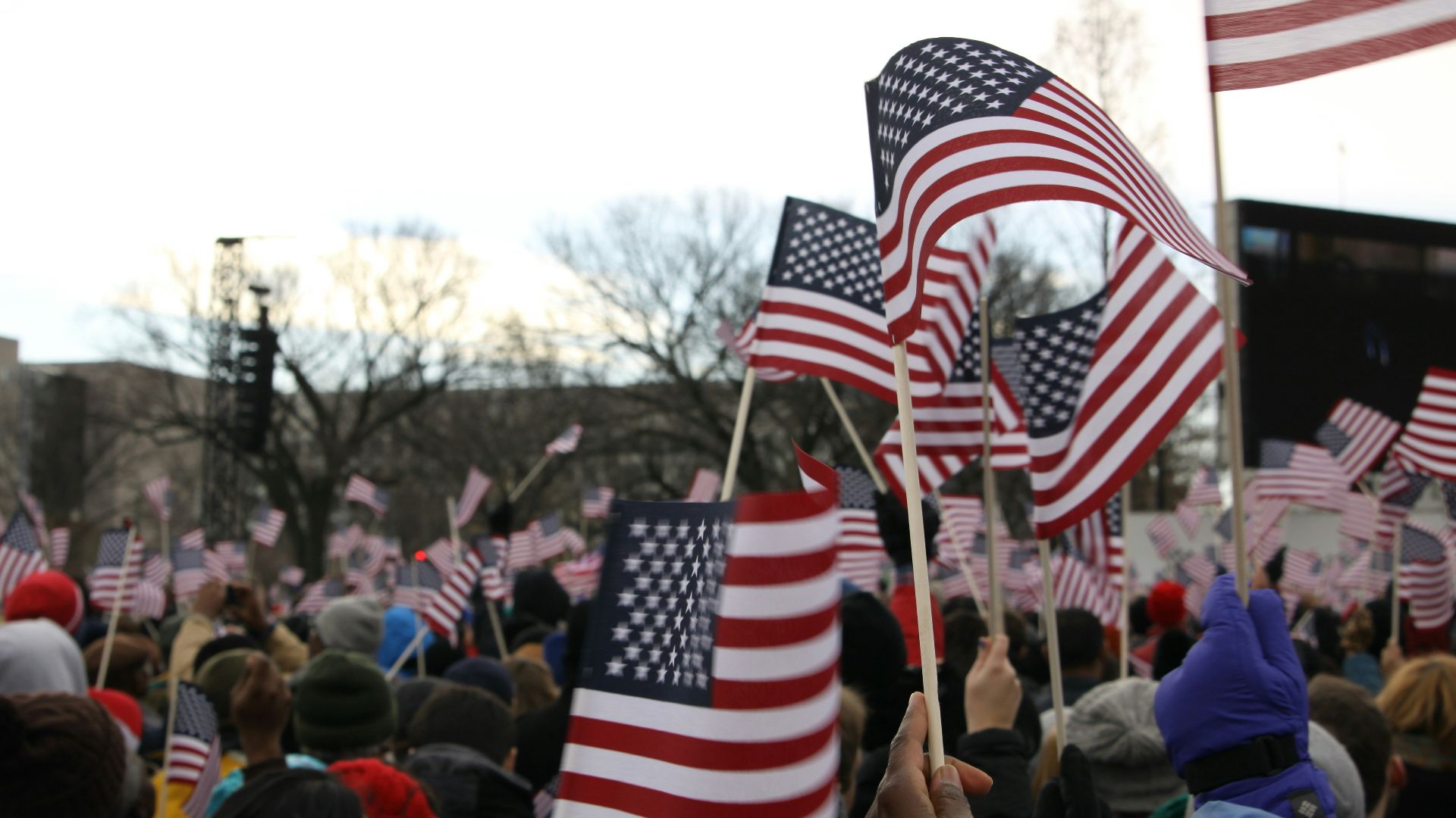 people holding us a flag during daytime