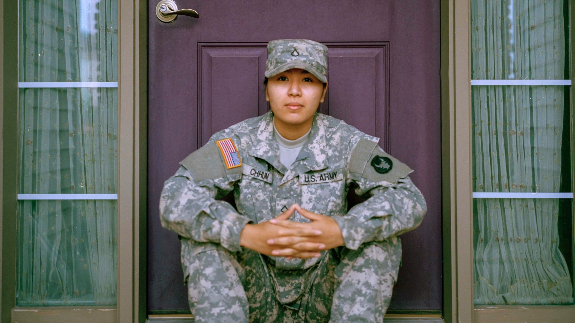 woman sitting in front of closed door