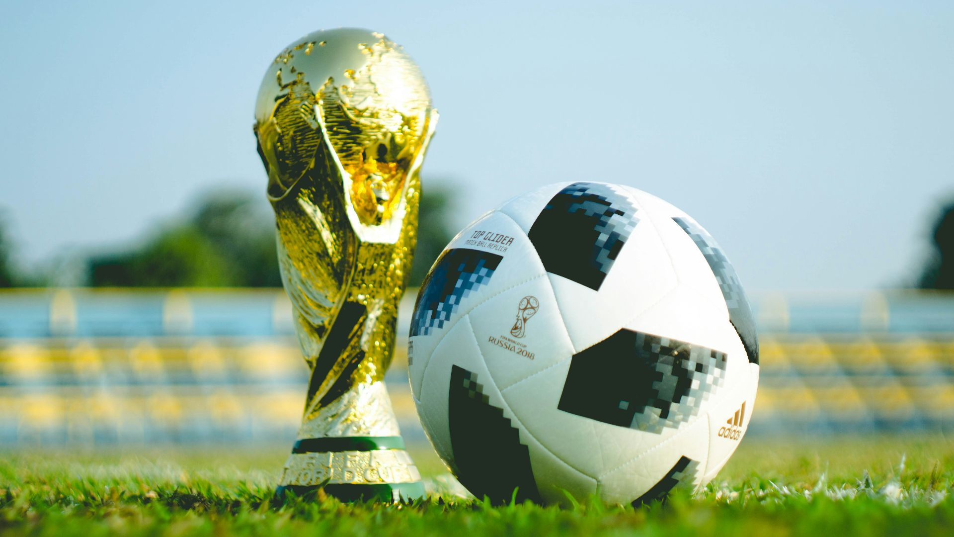 gold-colored trophy and soccerball