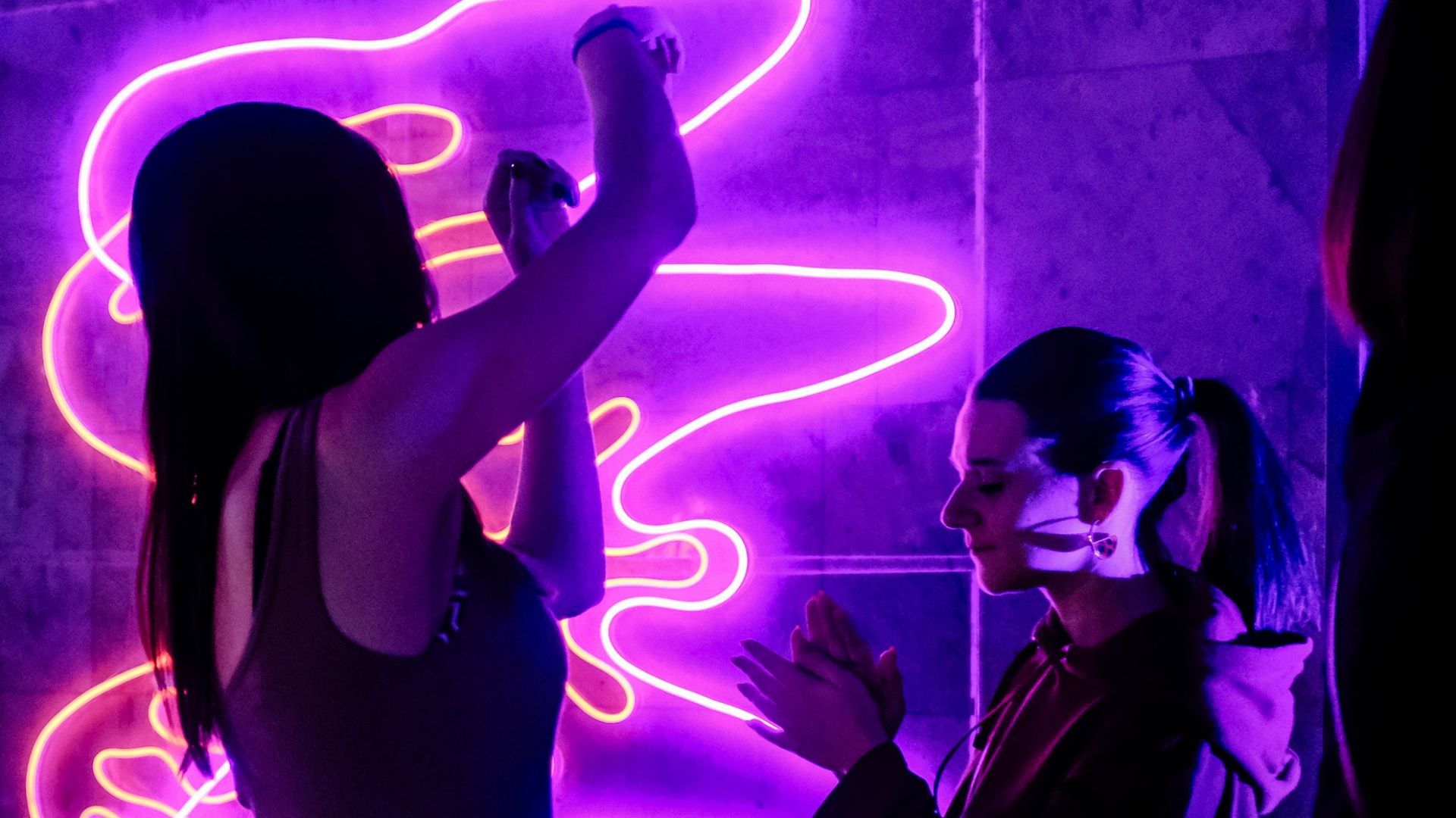 woman in black tank top singing on stage