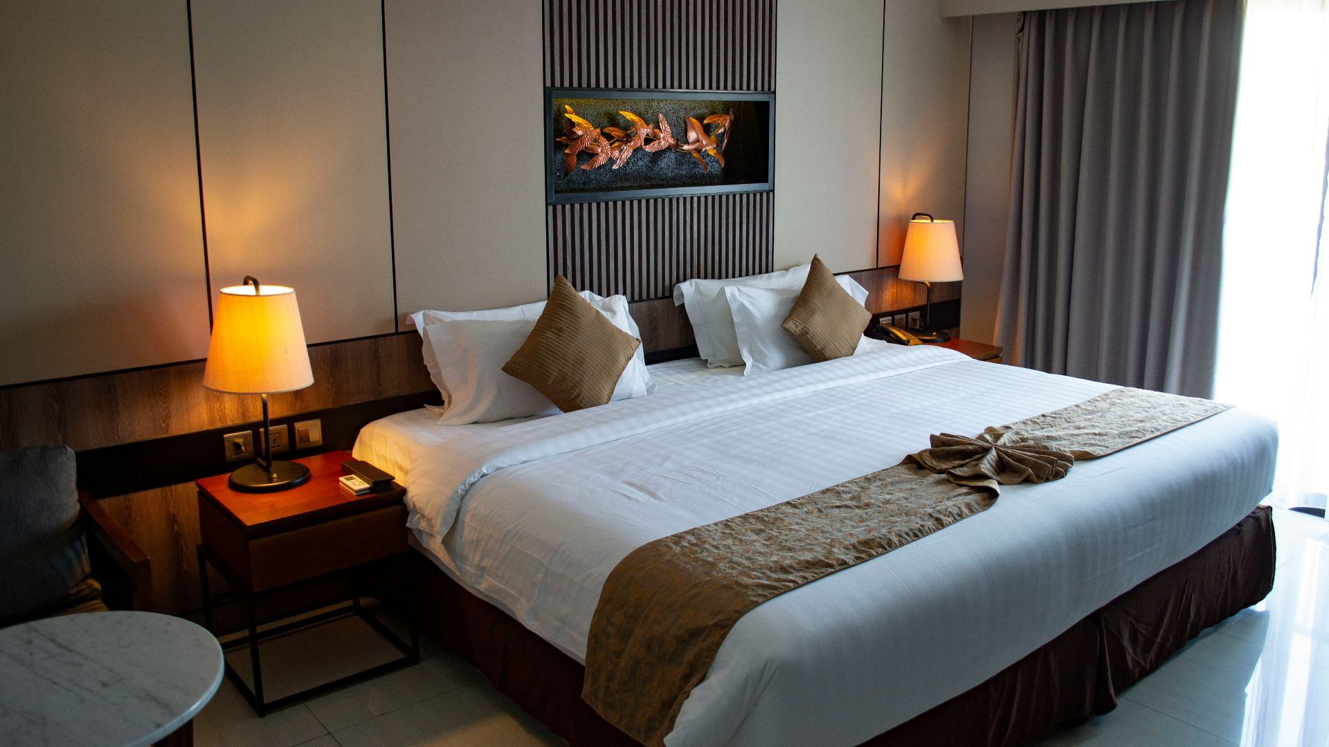 white bed linen with throw pillows