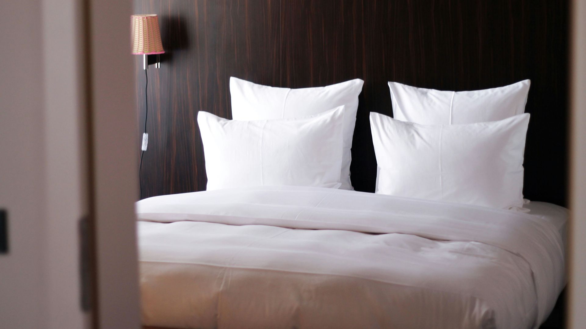 white bed pillow on white bed