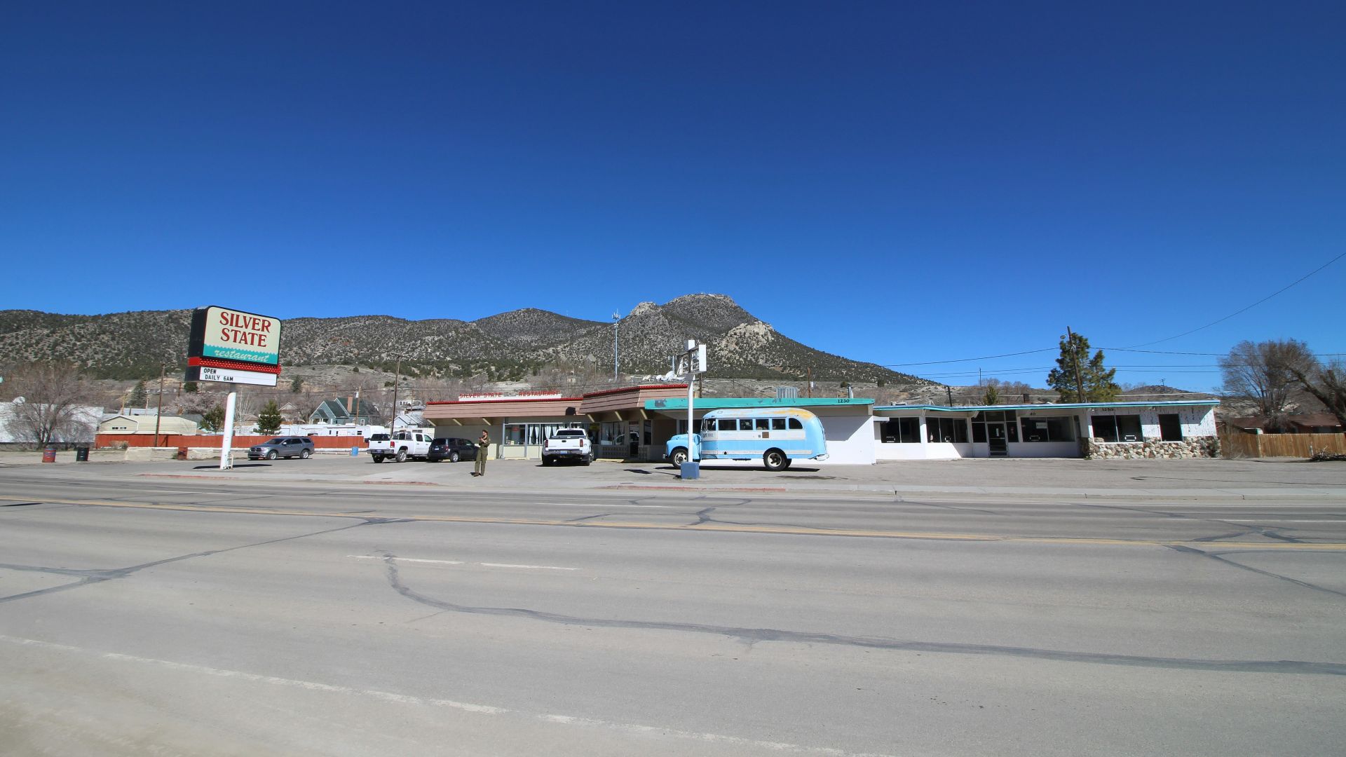 white and blue airplane on gray asphalt road during daytime
