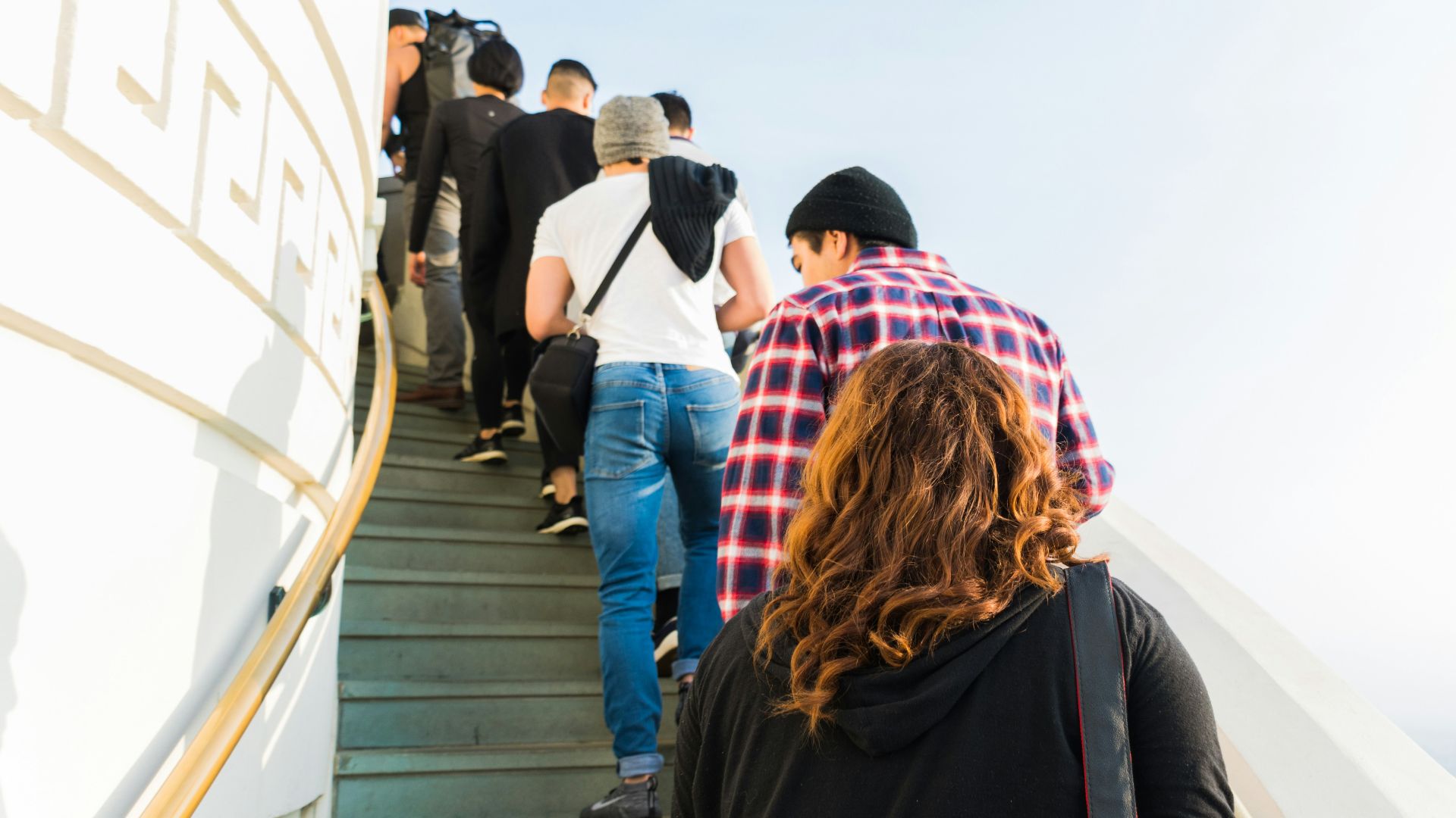 group of people on stairs under clear white sky