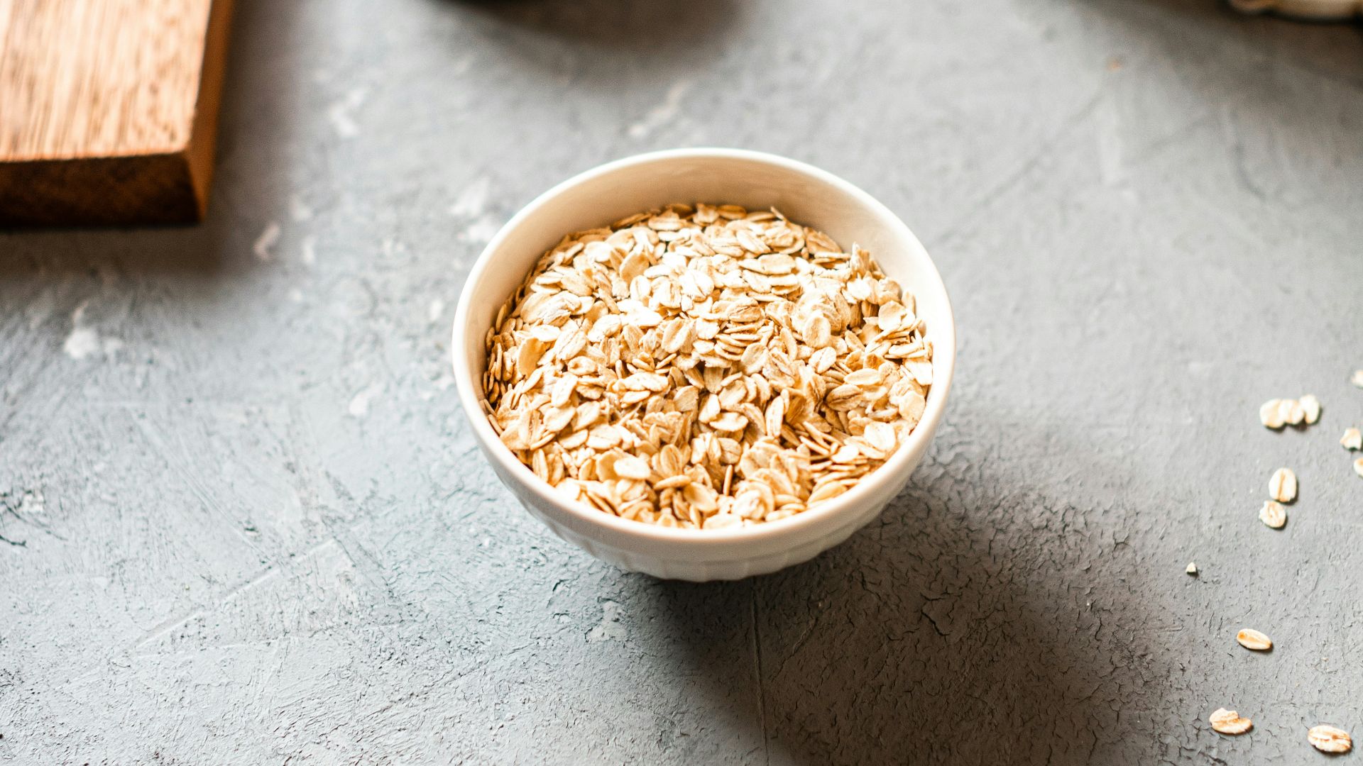 white ceramic bowl on brown wooden table