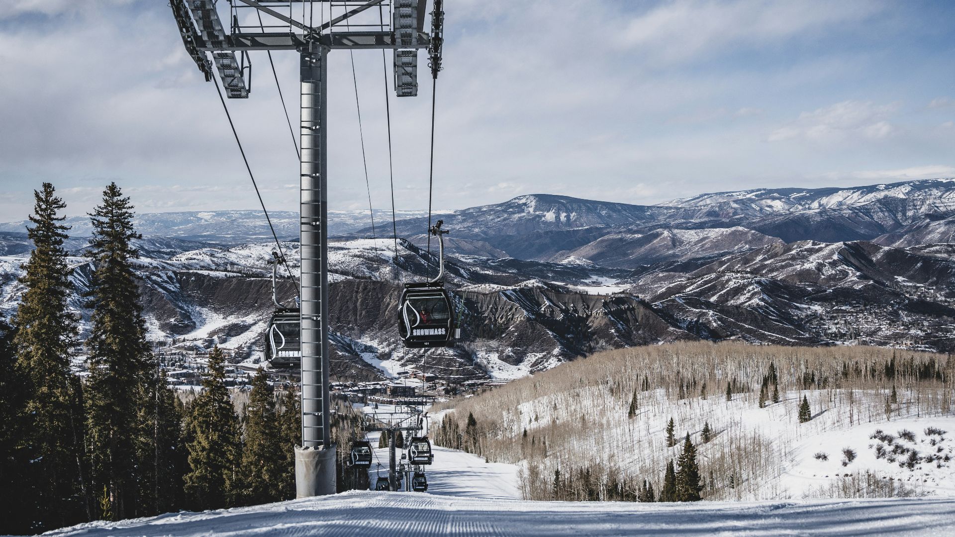 cable cars over snow covered mountain