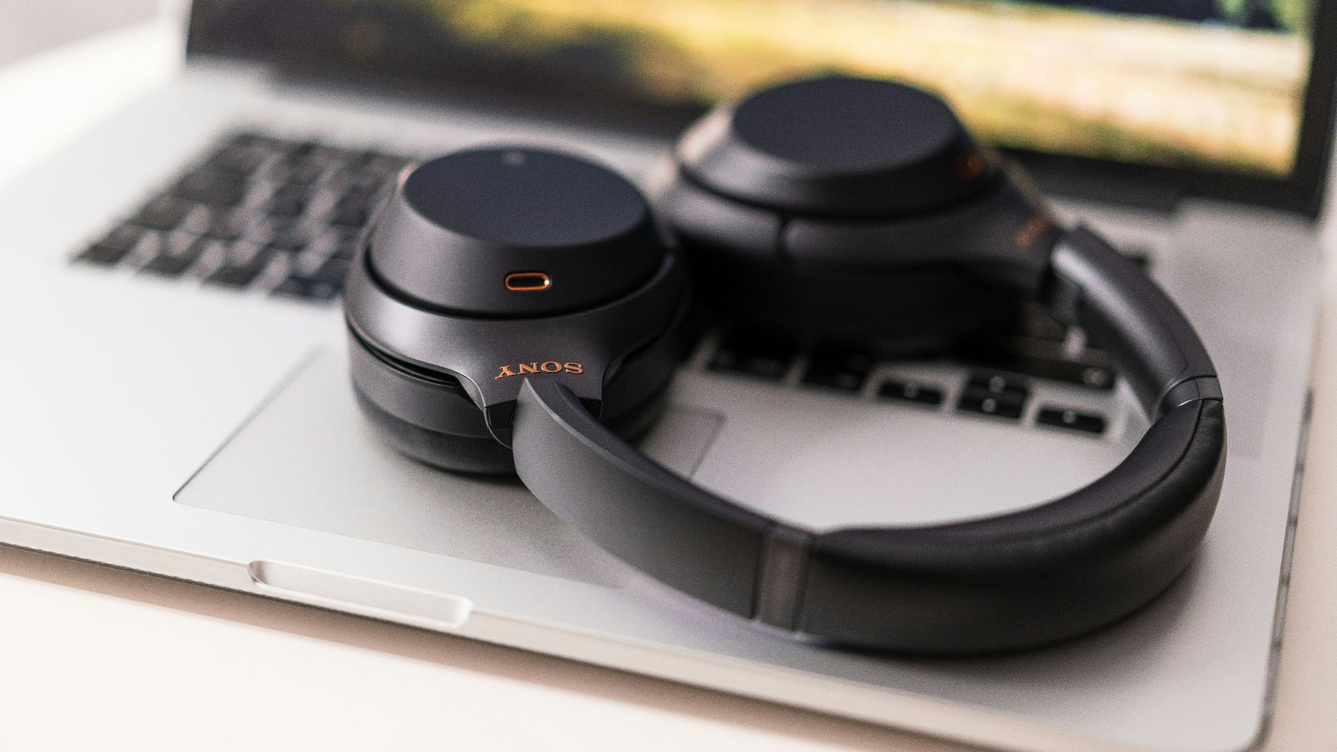 black and gray headphones on macbook pro