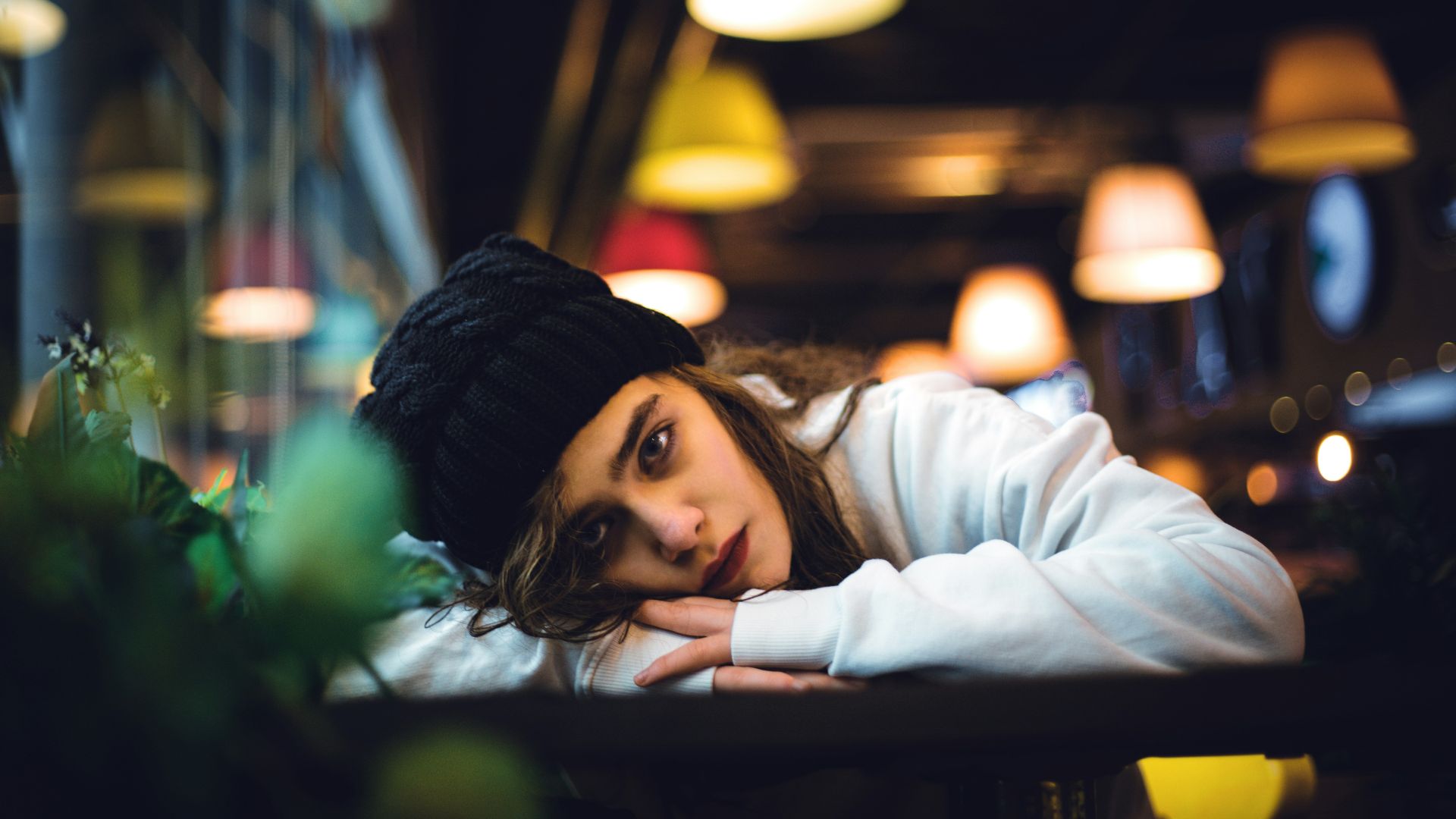 a woman sitting at a table in a restaurant