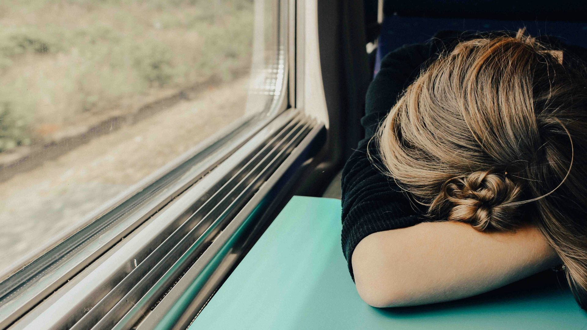 sleeping woman in train at daytime