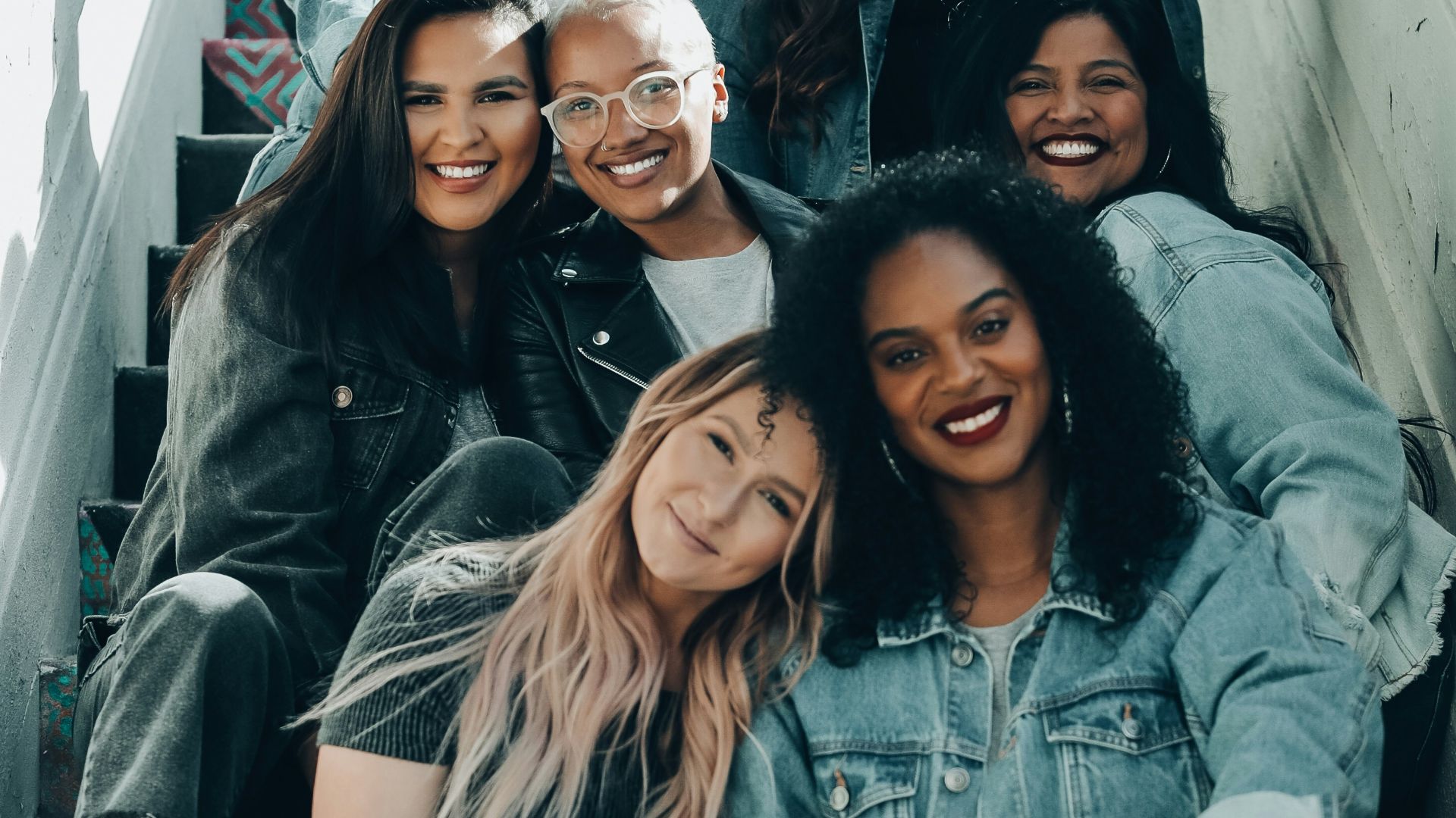 2 women sitting on black chair