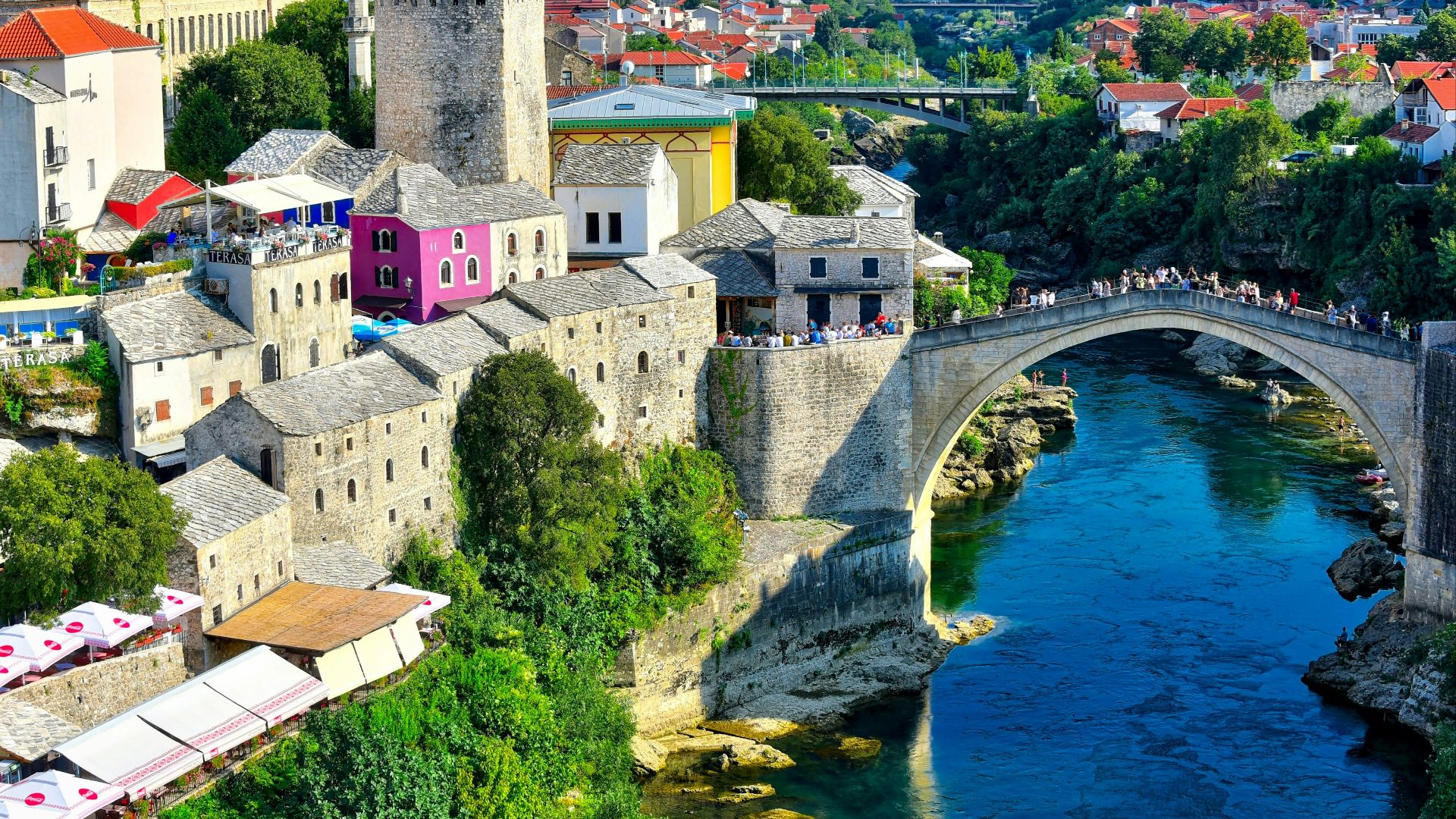 white and brown concrete building near body of water during daytime