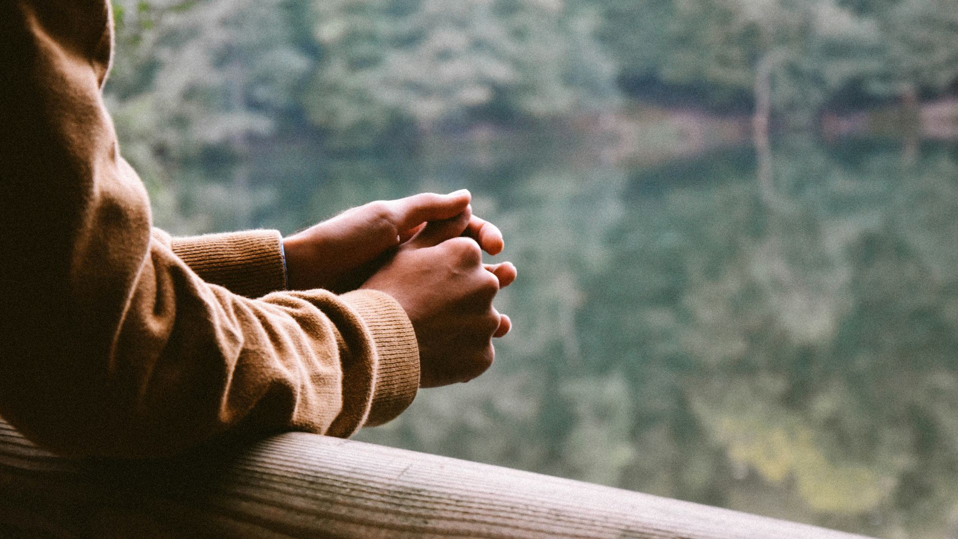 tilt-shift photography of person in brown jacket
