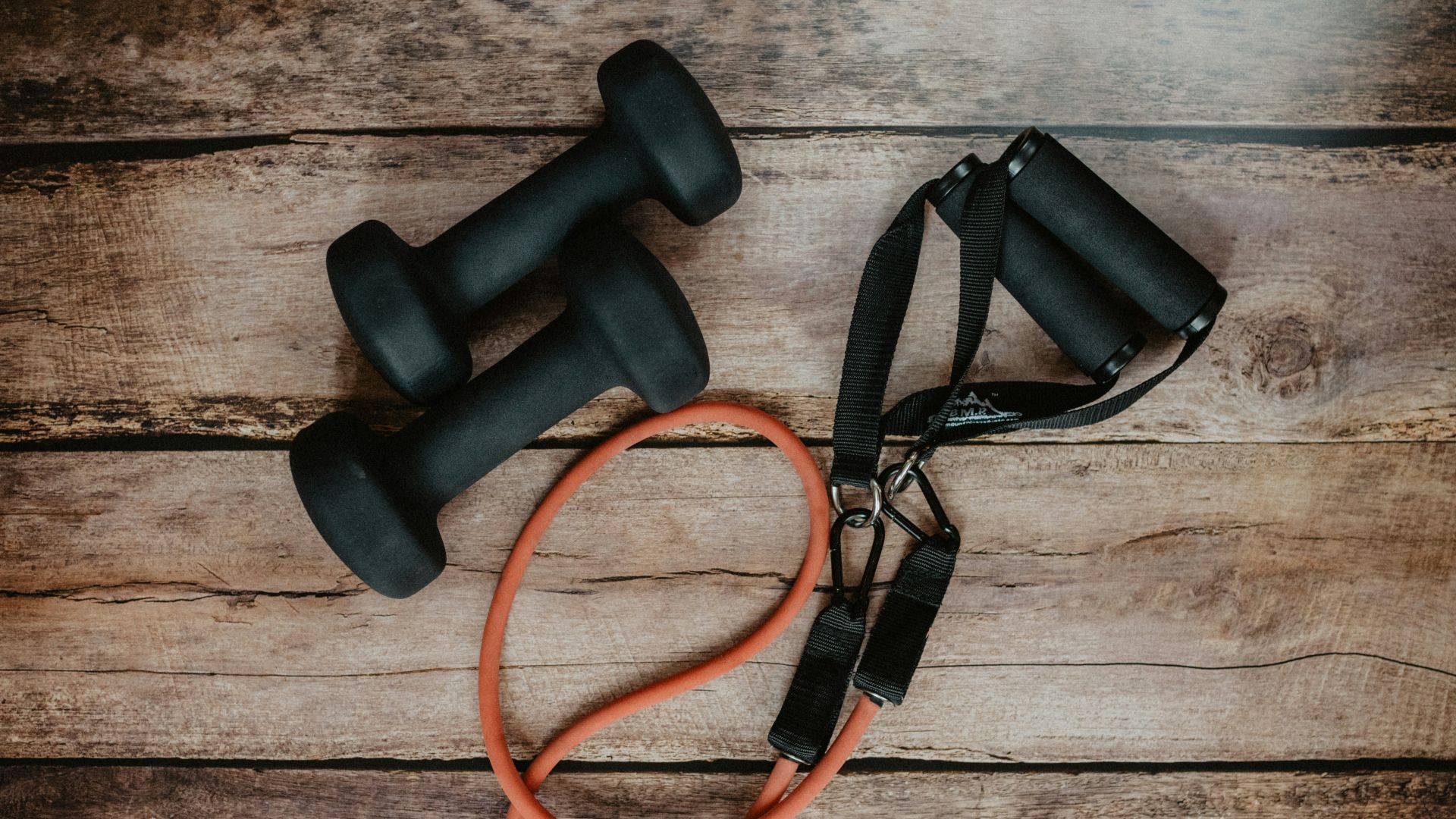 orange and black usb cable on brown wooden surface