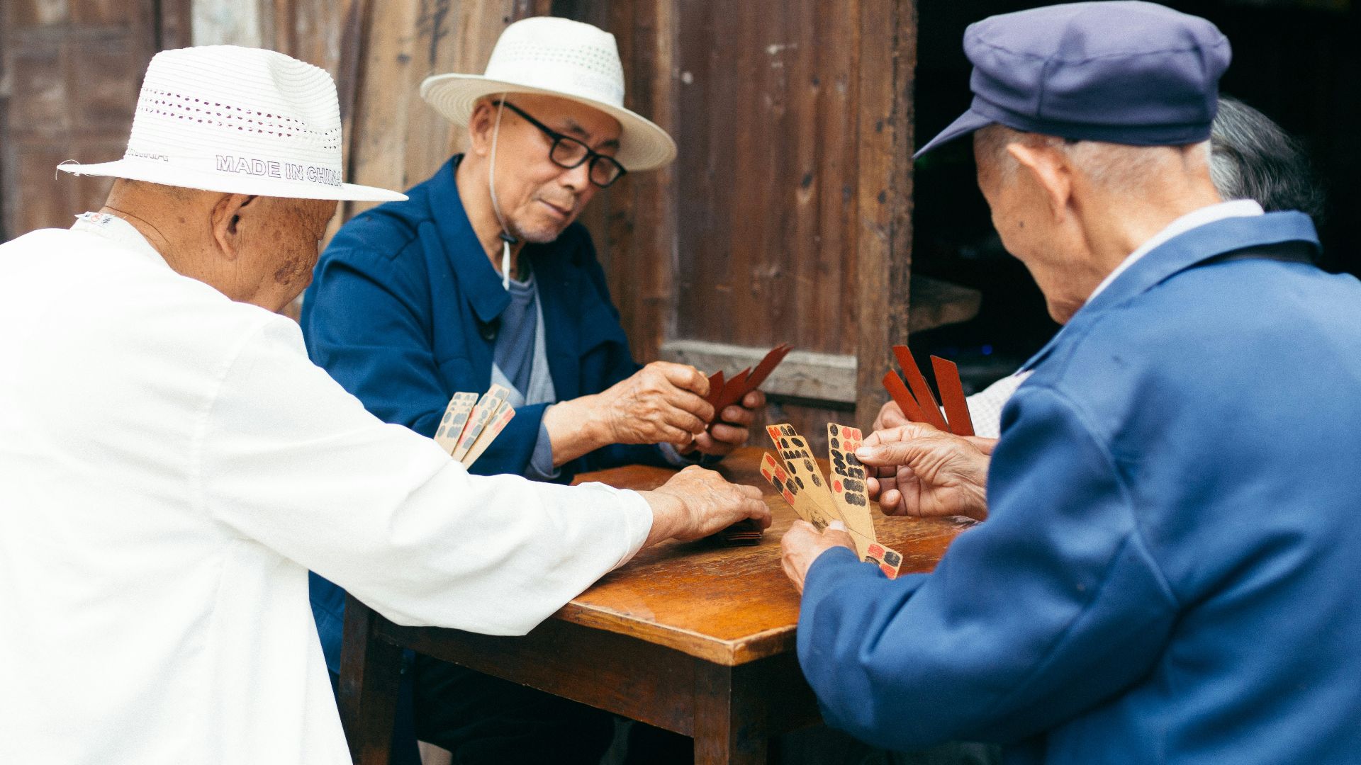 a group of elderly people playing a game of cards