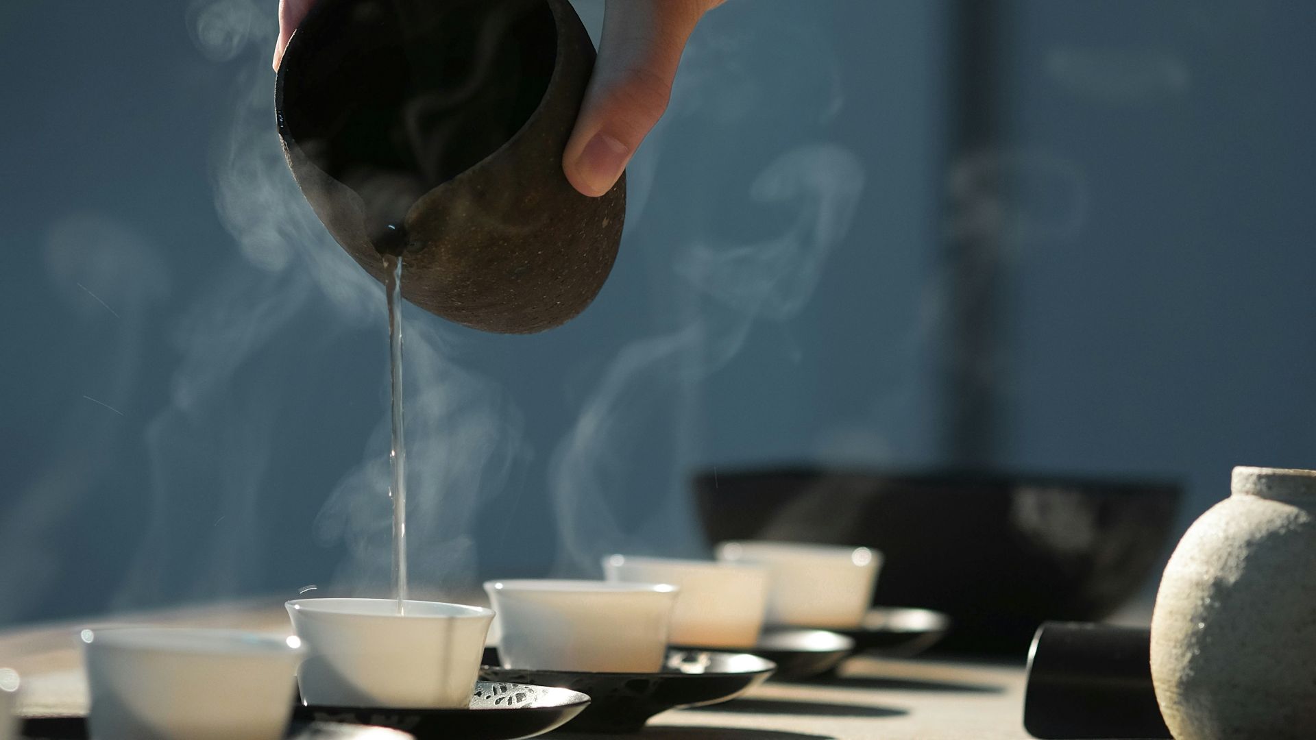 person pouring hot water on white cup