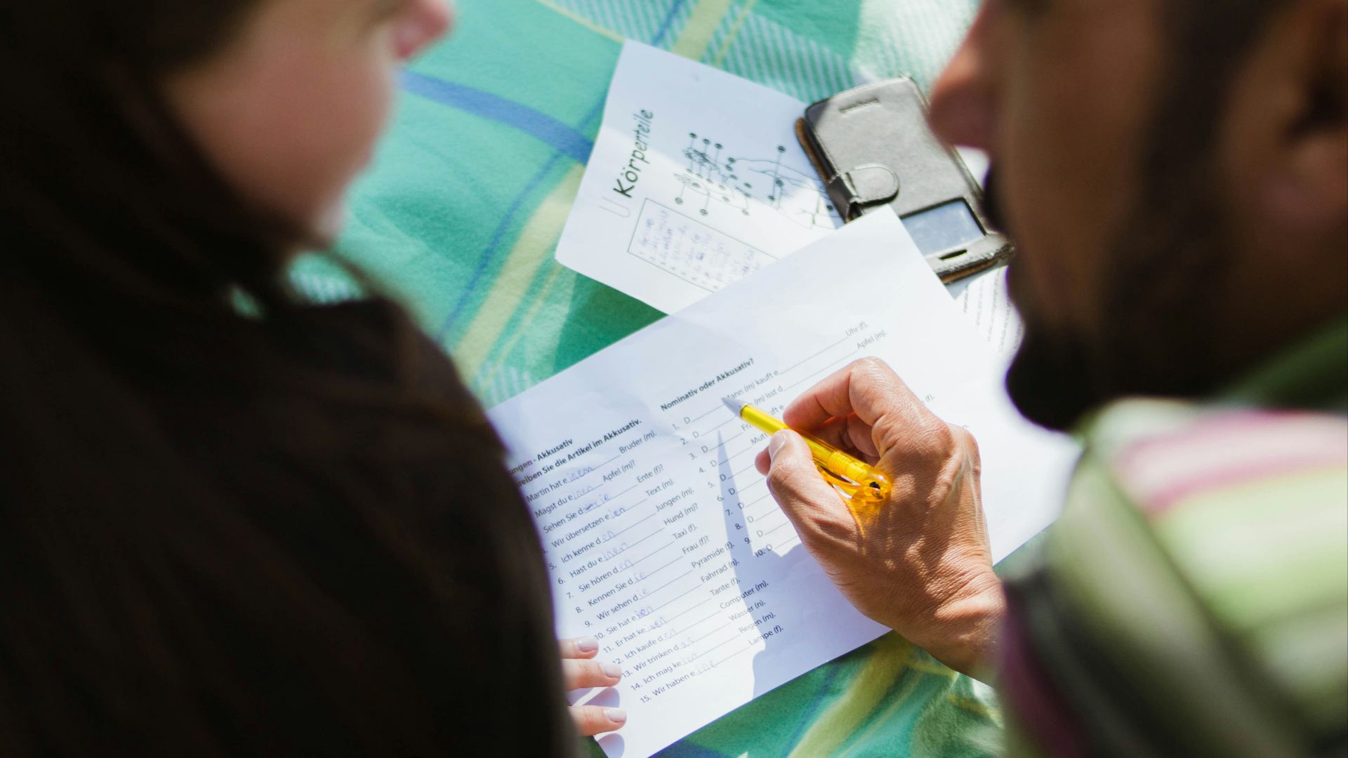 man in black shirt sitting beside woman in gray shirt