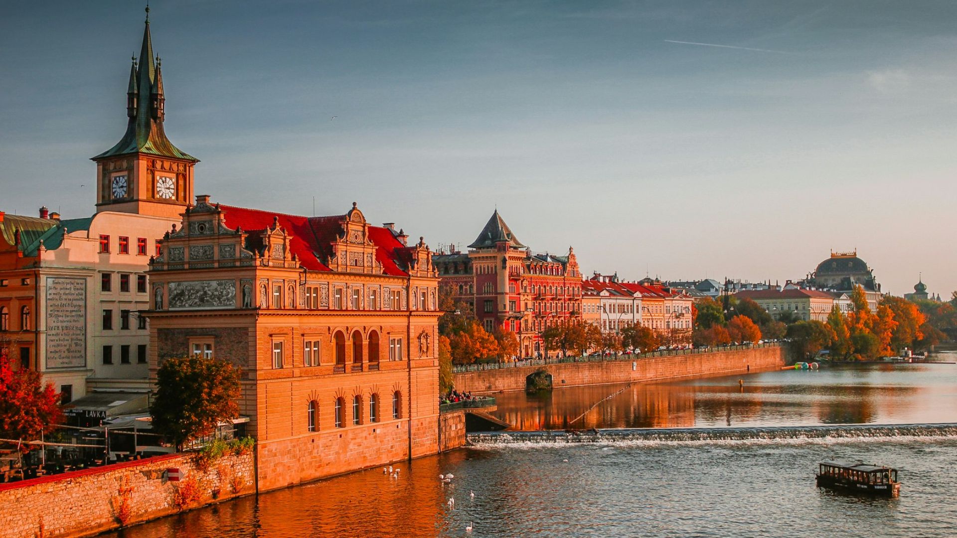 photo of boat on body of water near high-rise buildings