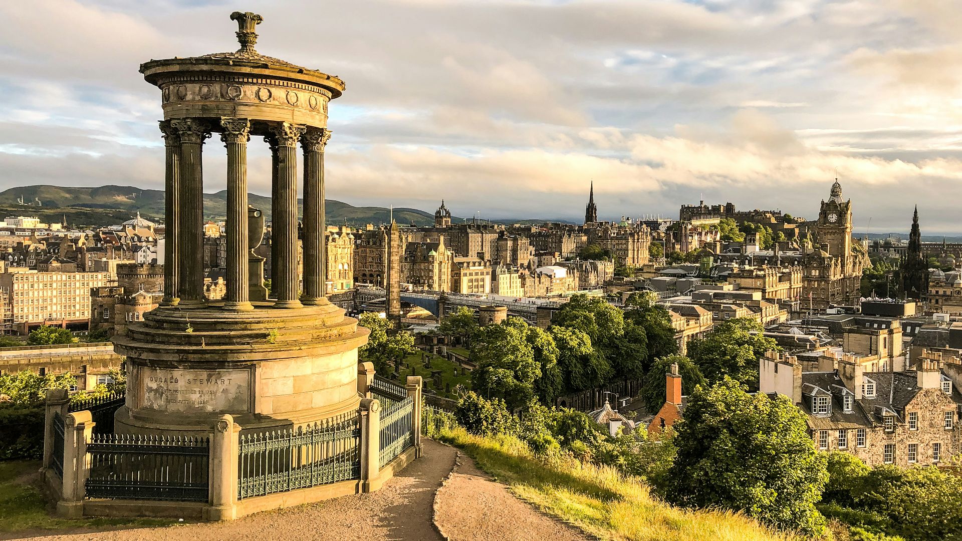 brown concrete house bell under white clouds