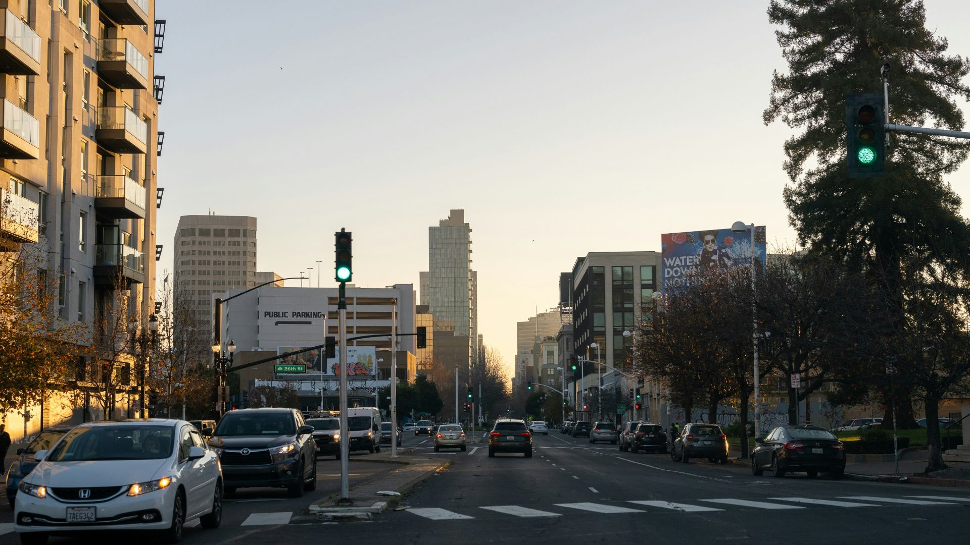 A city street filled with lots of traffic next to tall buildings