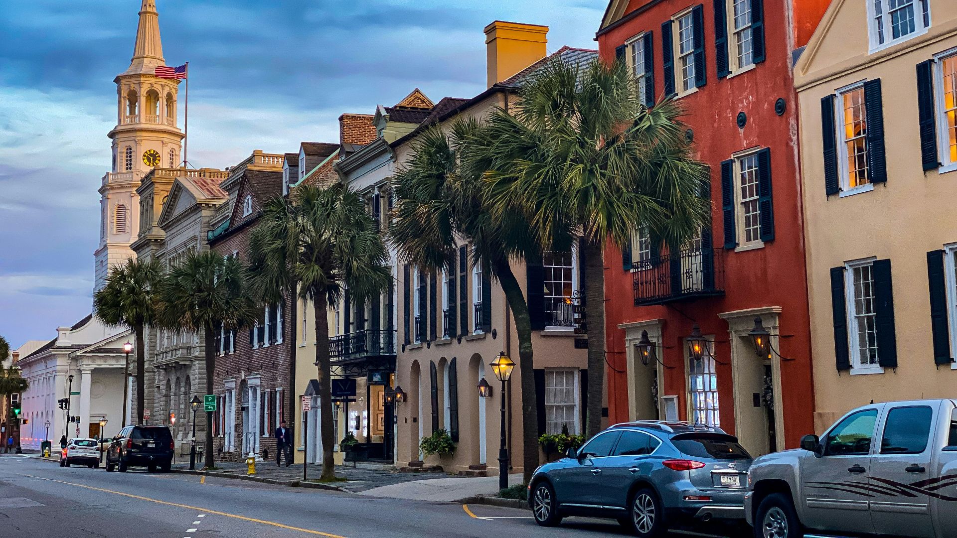 cars parked beside brown concrete building during daytime