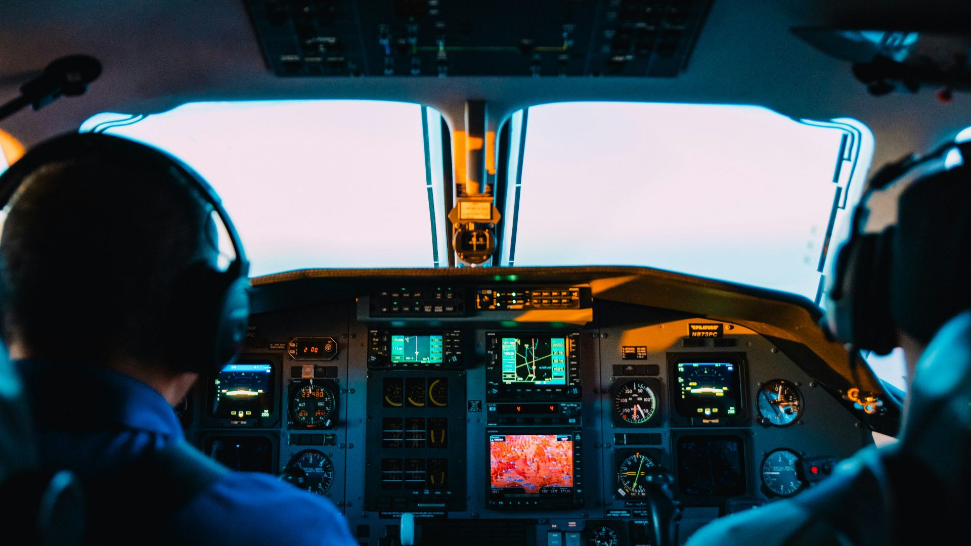 two men sitting on vehicle