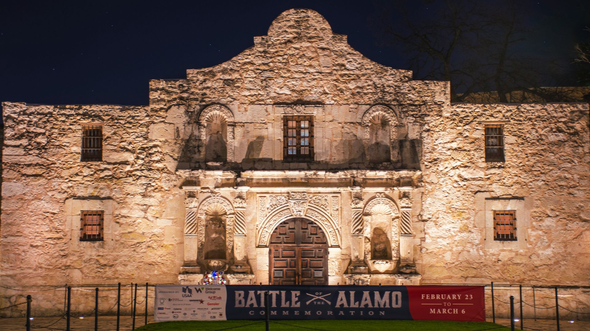 a large stone building with a sign in front of it