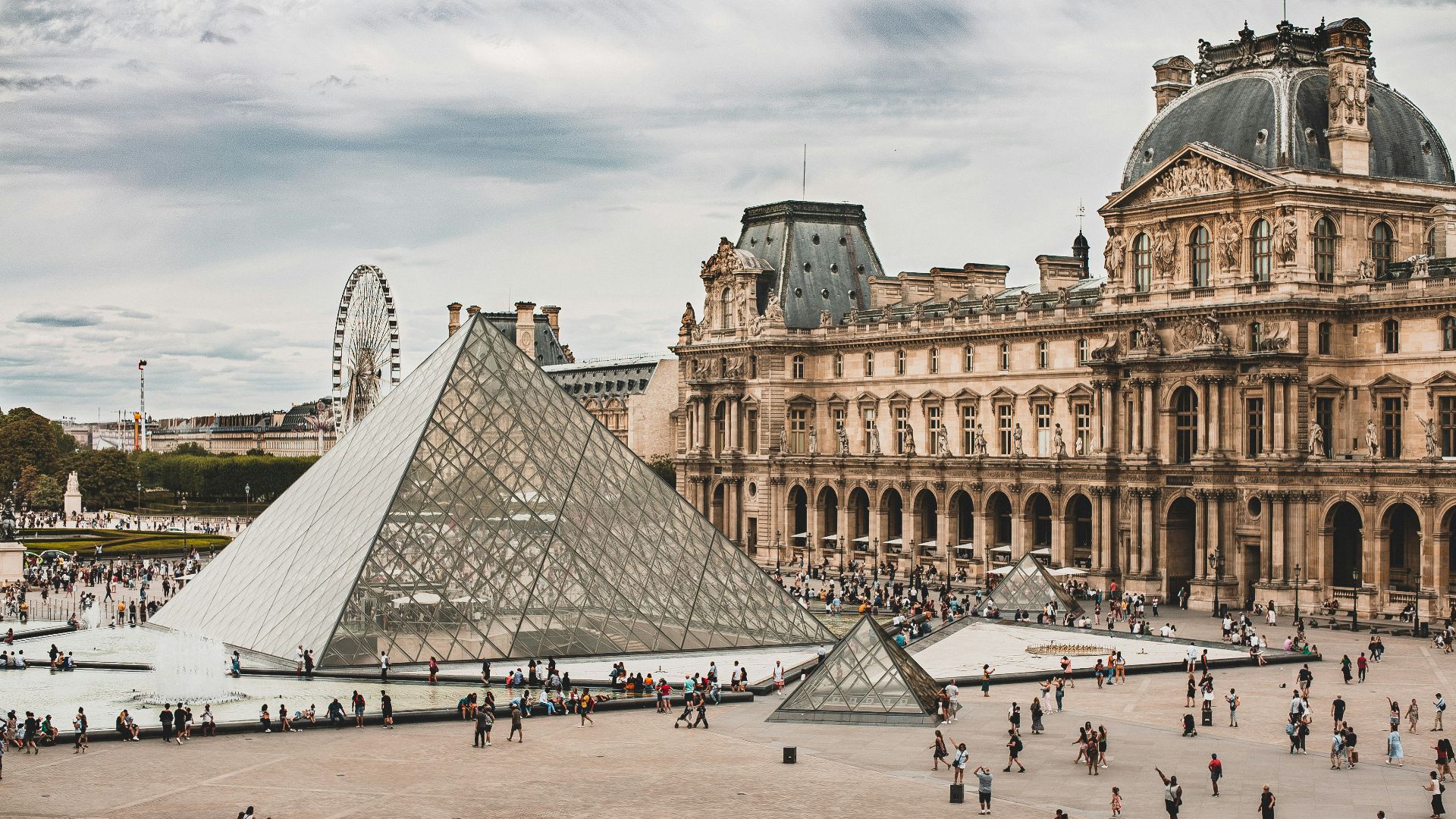 people gathering near Louvre Museum during daytime