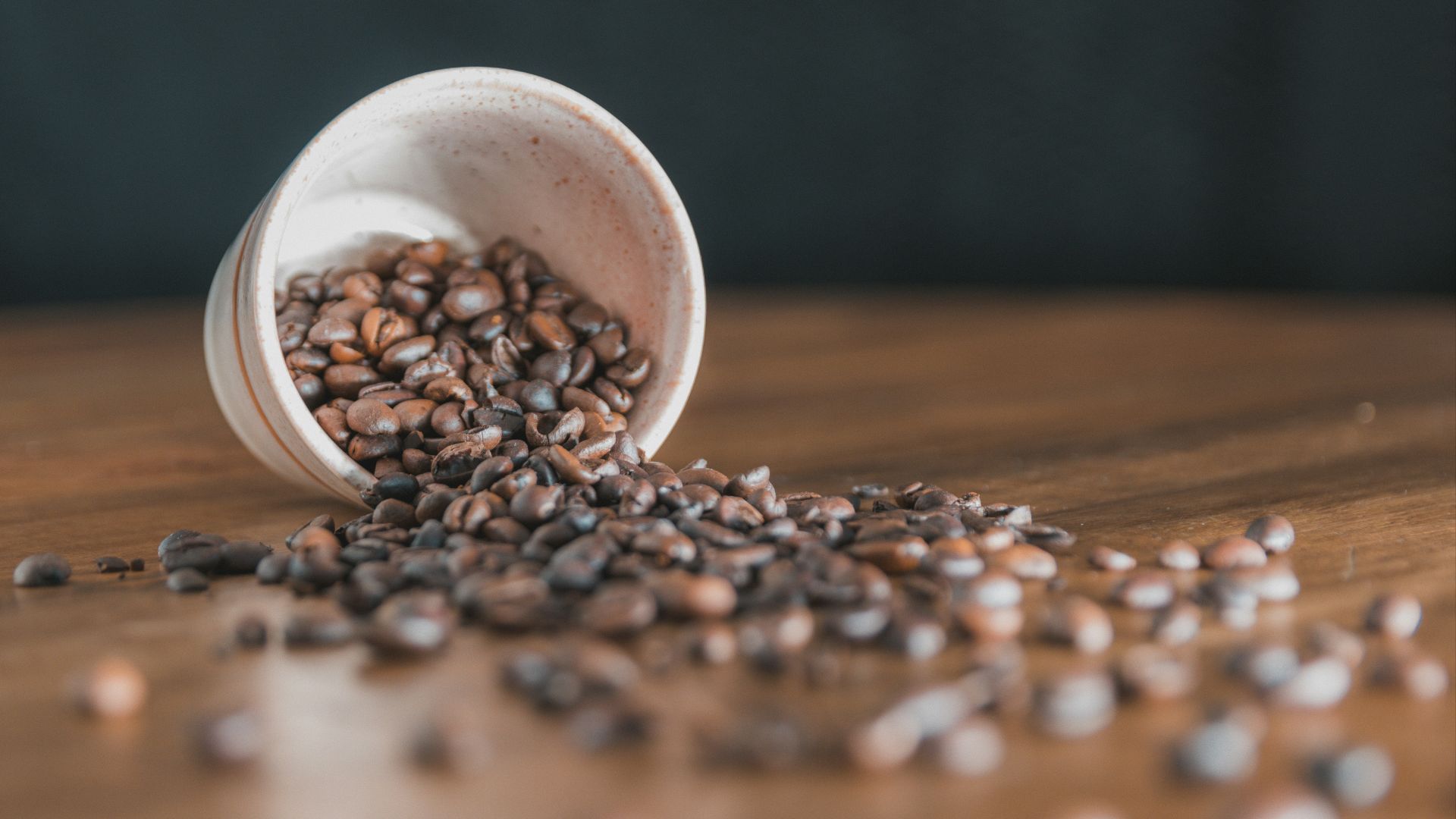 a white egg in a bowl of coffee beans