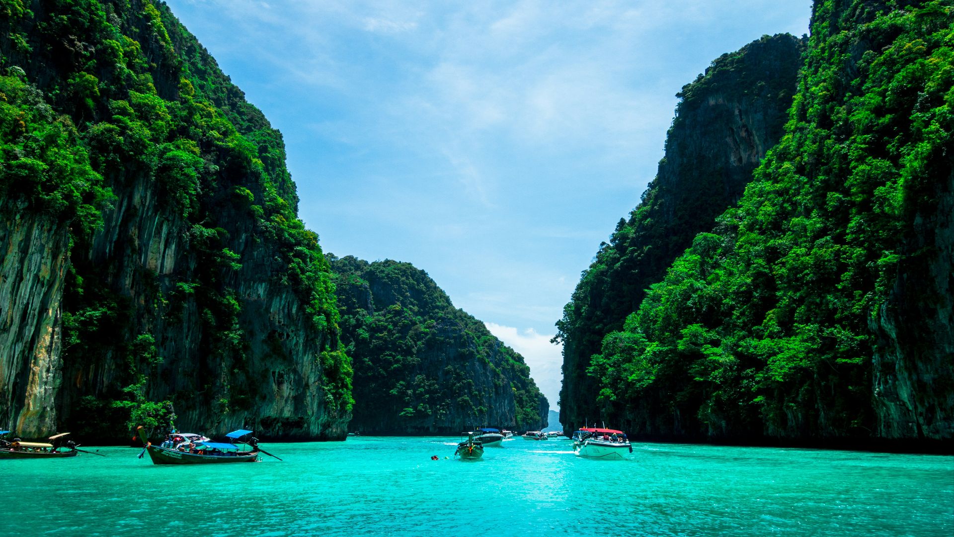 boats on sea near mountain during daytime